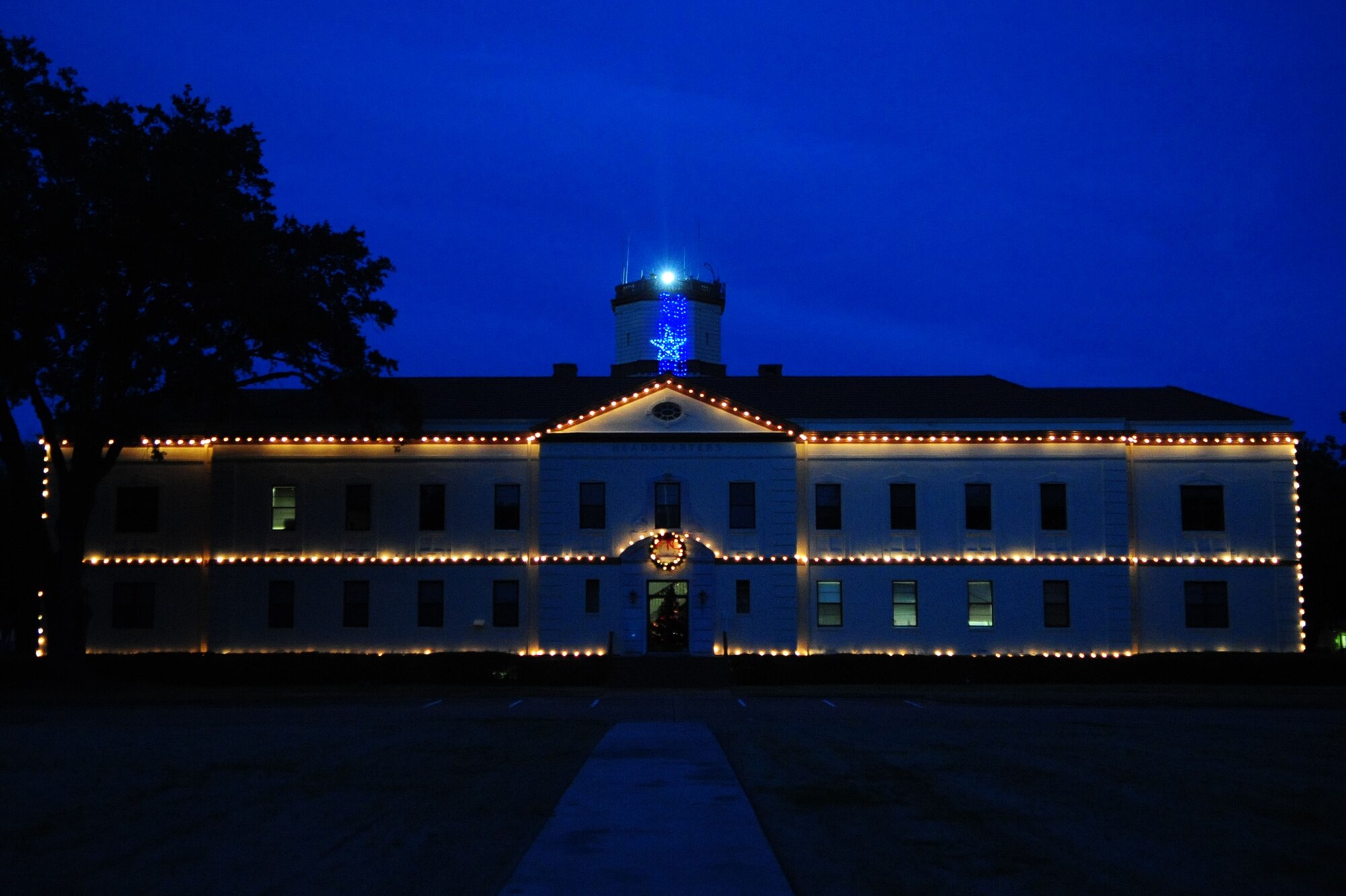 BARKSDALE AIR FORCE BASE, La. -- The lights of the 2d Bomb Wing headquarters welcome Airmen and visitors to the base, their warmth wishing Happy Holidays to all. (U.S. Air Force photo by Senior Airman Joanna M. Kresge)