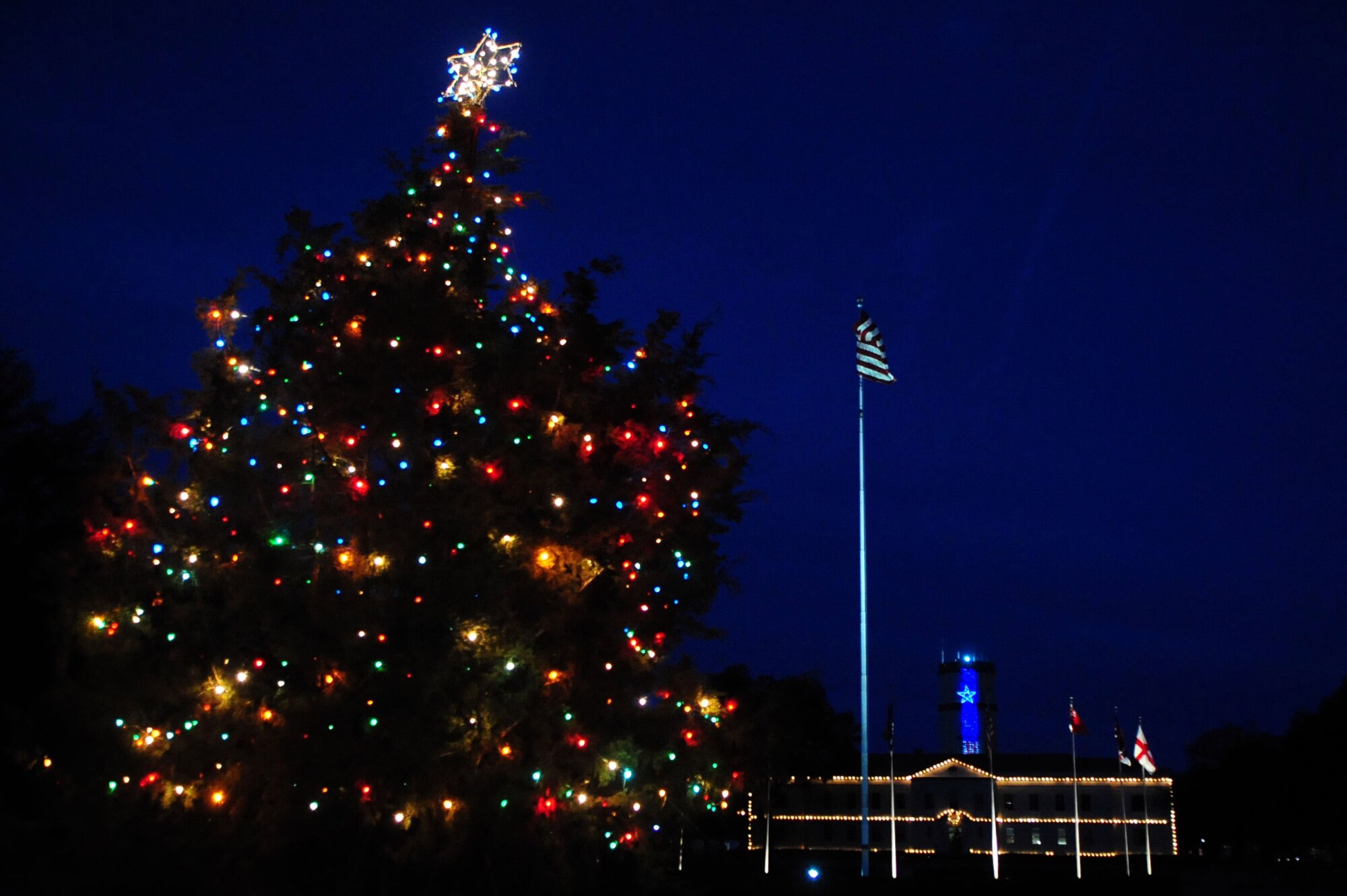 BARKSDALE AIR FORCE BASE, La. -- The lights of the 2d Bomb Wing headquarters and the base Christmas tree welcome Airmen and visitors to the base, their warmth wishing Happy Holidays to all. (U.S. Air Force photo by Senior Airman Joanna M. Kresge)