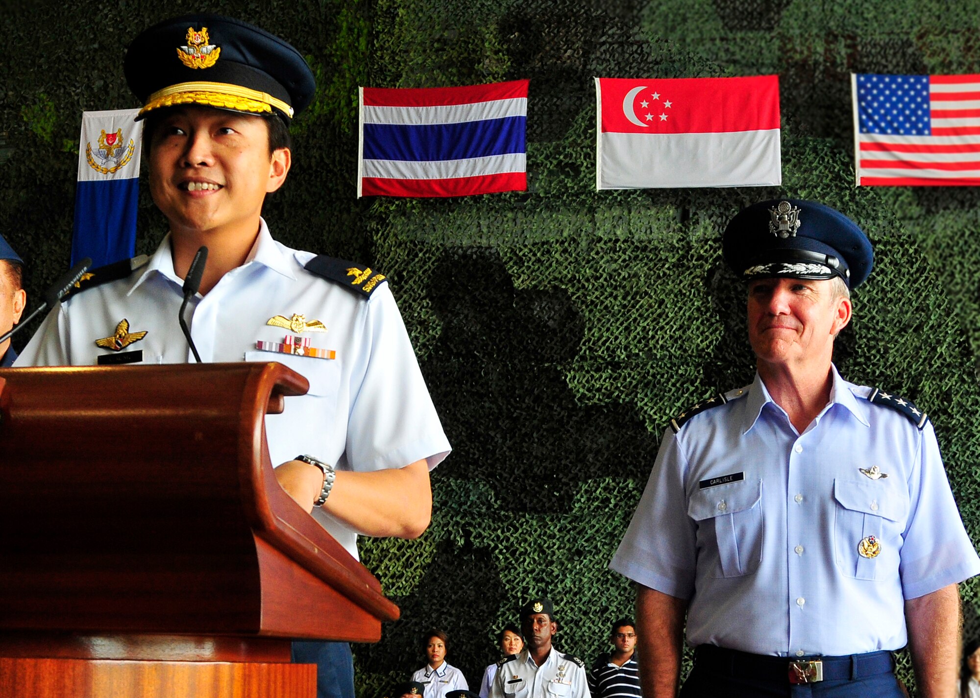 (Right) Lt. Gen. Hawk Carlisle, 13th Air Force commander, listens while Brigadier General Ng Chee Meng, Republic of Singapore Air Force chief of air force, speaks at the Cope Tiger 2010 opening ceremony Dec. 17 at Changi Air Base, Singapore.  Personnel from the U.S., Singaporean and Thai militaries will participate in the field training exercise scheduled for March 2010.  Cope Tiger is an annual, multilateral aerial large force exercise conducted in Thailand. (Courtesy photo)