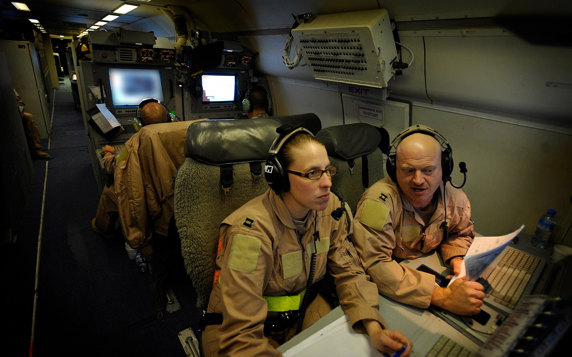 U.S. Air Force Capt. Bradley Webb (right), 7th Expeditionary Air Command and Control Squadron, Joint Surveillance Target Attack Radar System surveillance officer, stationed at Robins Air Force Base, Ga., deployed to Southwest Asia, educates U.S. Air Force Capt. Rikki Stewart, air weapons officer, about the JSTAR radar system, Dec. 18, 2009.  Captain Stewart, also stationed at Robins AFB, will take over as the surveillance officer and is currently learning the system on board the JSTARS. JSTARS is a command and control platform that conducts ground surveillance to support attack operations and contributes to the disruption of enemy forces. (U.S. Air Force photo/Staff Sgt. Angelita Lawrence)
