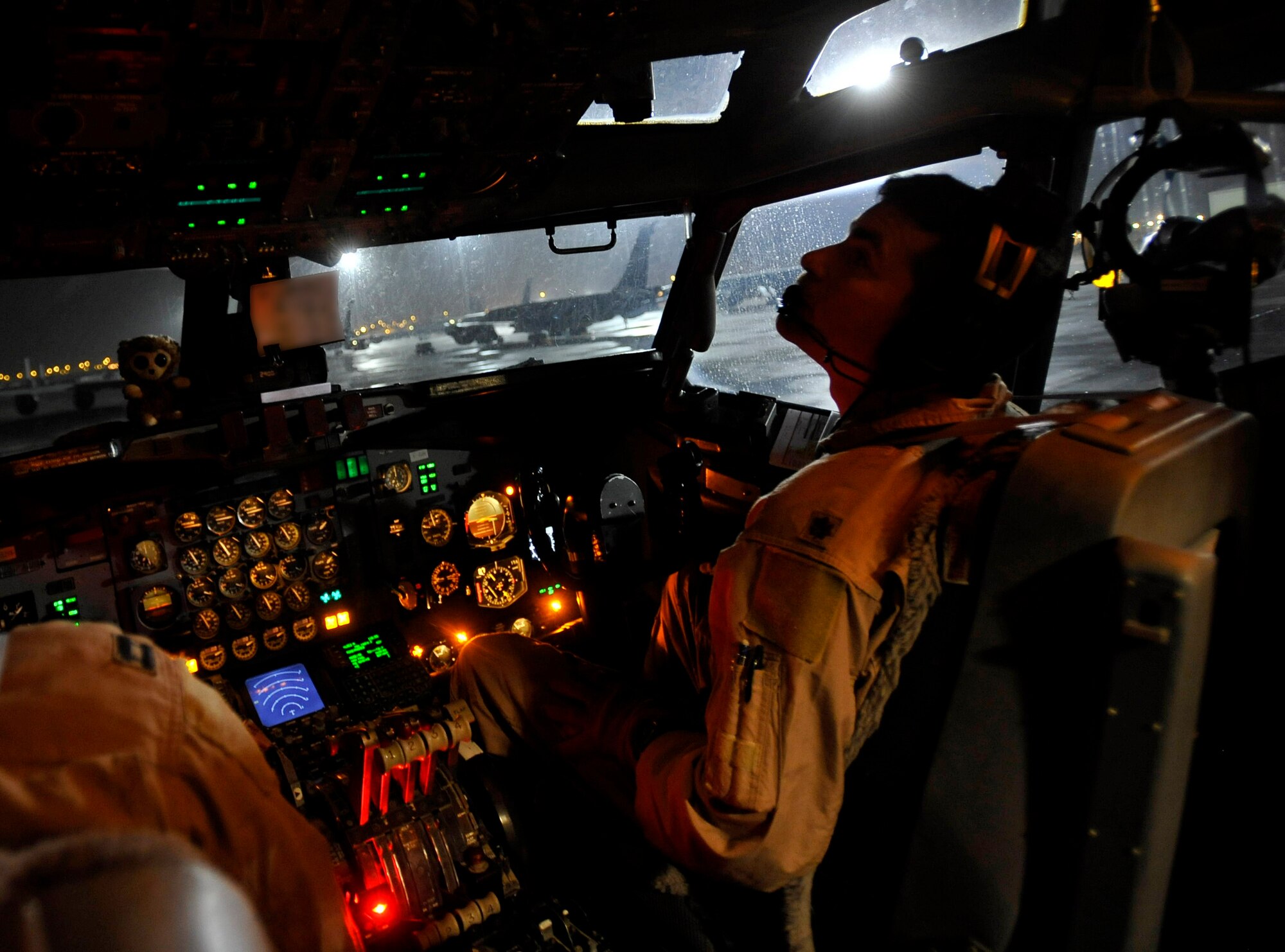 U.S. Air Force Maj. Edward King, 7th Expeditionary Air Command and Control Squadron, Joint Surveillance Target Attack Radar System co-pilot, stationed at Robins Air Force Base, Ga., deployed to Southwest Asia, completes his checklist before engine start, Dec. 18, 2009.  JSTARS is a command and control platform that conducts ground surveillance to support attack operations and contributes to the disruption of enemy forces. (U.S. Air Force photo/Staff Sgt. Angelita Lawrence)