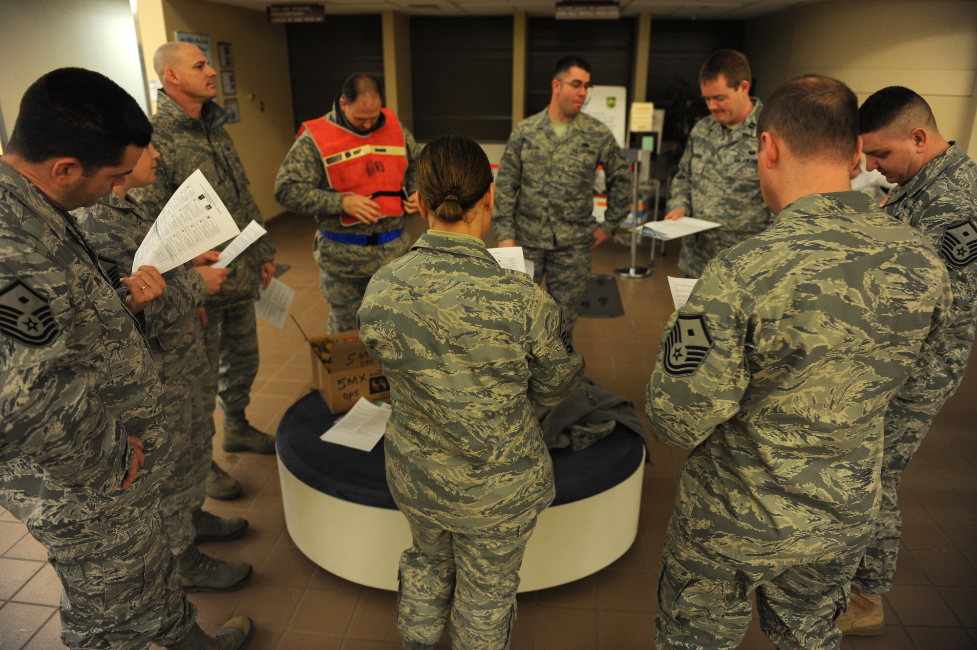 MINOT AIR FORCE BASE, N.D. -- Unit first sergeants gather to discuss to discuss sweep proceedures during Operation PrairieHawk 10A here Dec. 19. First sergeants from both the 5th Bomb Wing and the 91st Missile Wing checked vehicles after they entered the installation and directed Airmen to the clinic for the urinalysis inspection during the sweep. The gate sweep was ordered to both ensure the fitness for duty of Airmen at Minot AFB and to present a visible and present deterrent to drug use. (U.S. Air Force photo by Staff Sgt. Stacy Moless)