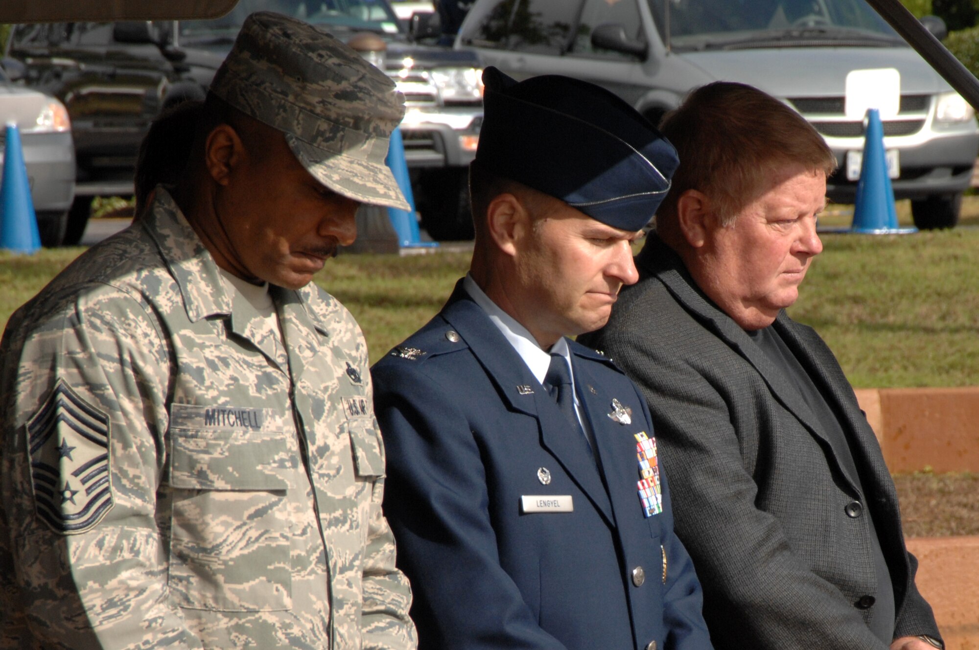 Col. Greg Lengyel, 1st Special Operations Wing commander, Chief Master Sgt. Dexter Mitchell, 1st SOW command chief, and retired Air Force Brig. Gen. George Gray listen to the invocation at the commemoration of the 20th anniversary of Operation Just Cause at the Hurlburt Field Airpark Dec. 18. The event was also attended by servicemembers who participated in the operation. (U.S. Air Force photo by Senior Airman Matthew Loken) 