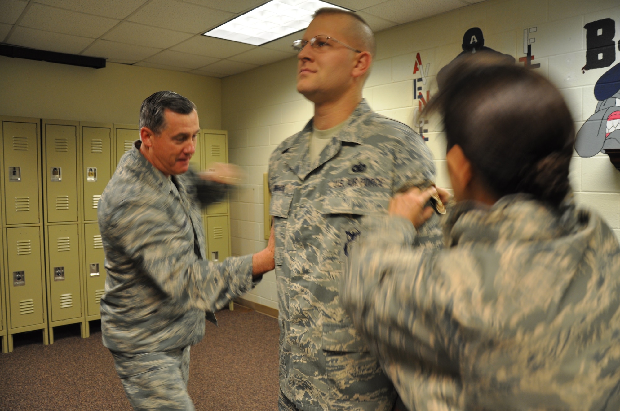 Brig. Gen. O.G. Mannon, 82nd Training Wing commander, and Col. Kimberley Ramos, 82nd Mission Support Group commander, tack technical sergeant stripes on Tech. Sgt. Daniel Nienhaus, an 82nd Security Forces Squadron investigator, Dec. 22 after he was selected for promotion under the Stripes for Exceptional Performers program. The STEP program releases a limited number of slots each year to major commands to fill for ranks E-5 through E-7. (U.S. Air Force Photo/ Airman 1st Class Adawn Kelsey)