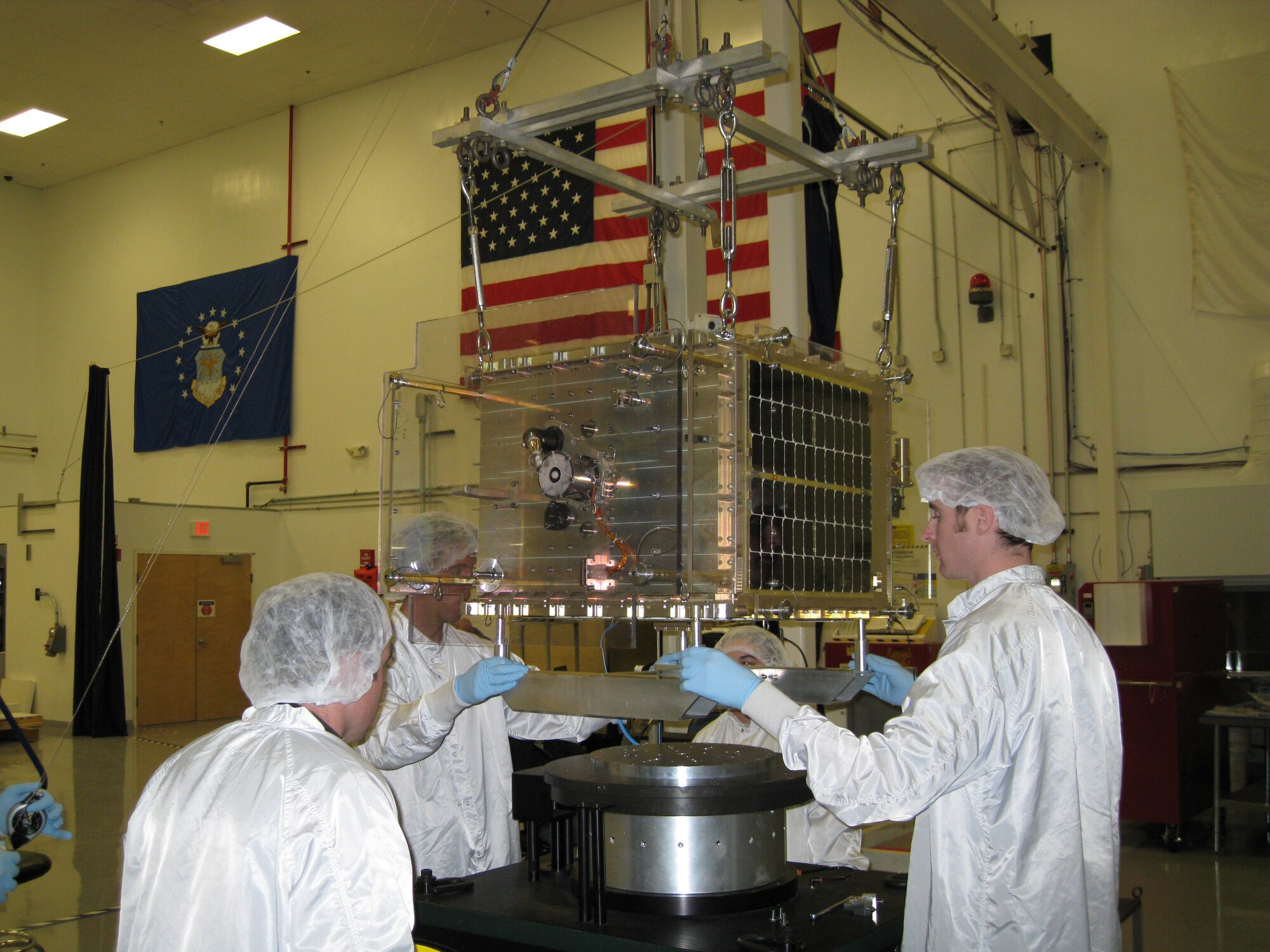 Cadets and contractors prepare FalconSAT-5 for a battery of environmental tests at the Air Force Research Laboratory at Kirtland Air Force Base, N.M., Nov. 12, 2009, prior to declaring the satellite spaceflight-worthy. Cadets briefed senior officials from the AFRL and Air Force Space Command on the status of FalconSAT-5 as well as FalconSAT-3, which has been on orbit since March 2007. (U.S. Air Force photo)