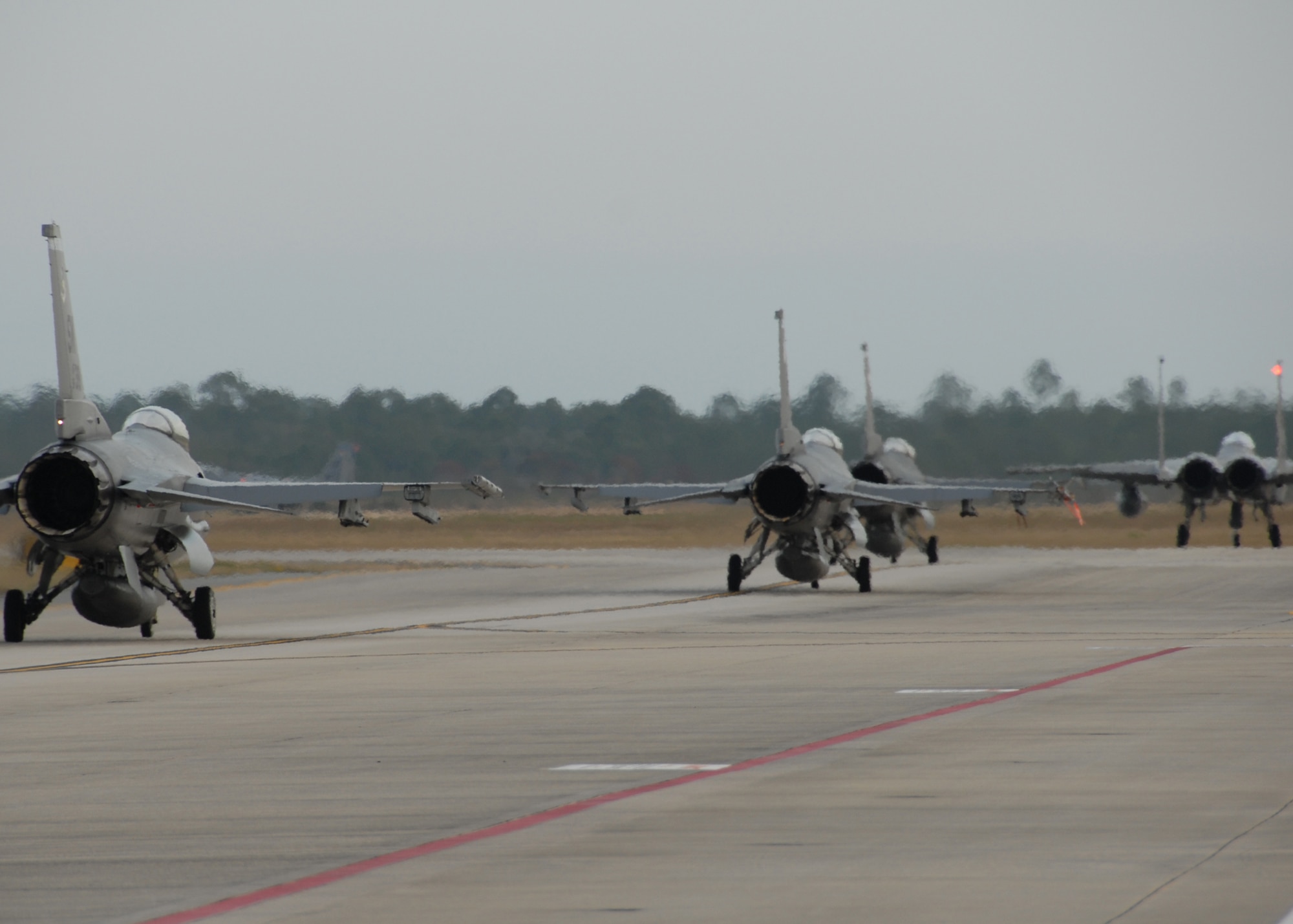 F-16s from Mountain Home Air Force Base, Idaho, taxi down the runaway during a Weapon System Evaluation Program 10-03 on Dec. 4 at Tyndall AFB, Fla. The WSEP program, run by the 53rd Weapons Evaluation Group, 83rd Fighter Weapons Squadron, is used to evaluate the effectiveness and suitability of combat air force weapon systems for aircrew and maintainers. The 53rd Wing headquarters is located on Eglin AFB, Fla.  (U.S. Air Force photo/Samuel King, Jr.)

