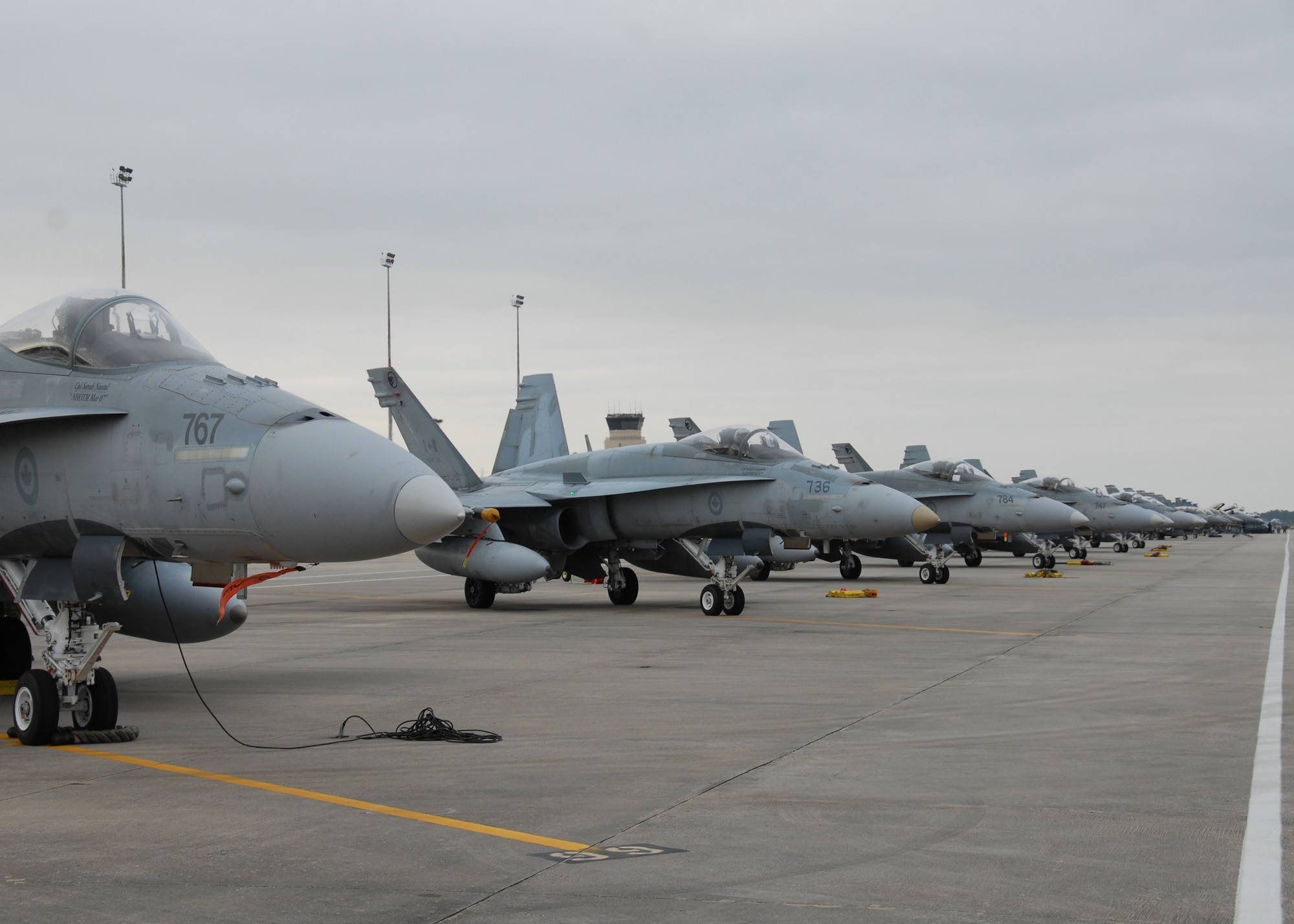 F-18 Hornets from the 409th Canadian Air Force line the runway during a Weapon System Evaluation Program 10-03 on Dec. 4 at Tyndall Air Force Base, Fla. The WSEP program, run by the 53rd Weapons Evaluation Group, 83rd Fighter Weapons Squadron, is used to evaluate the effectiveness and suitability of combat air force weapon systems for aircrew and maintainers. The 53rd Wing headquarters is located on Eglin AFB, Fla.  (U.S. Air Force photo/Samuel King, Jr.)

