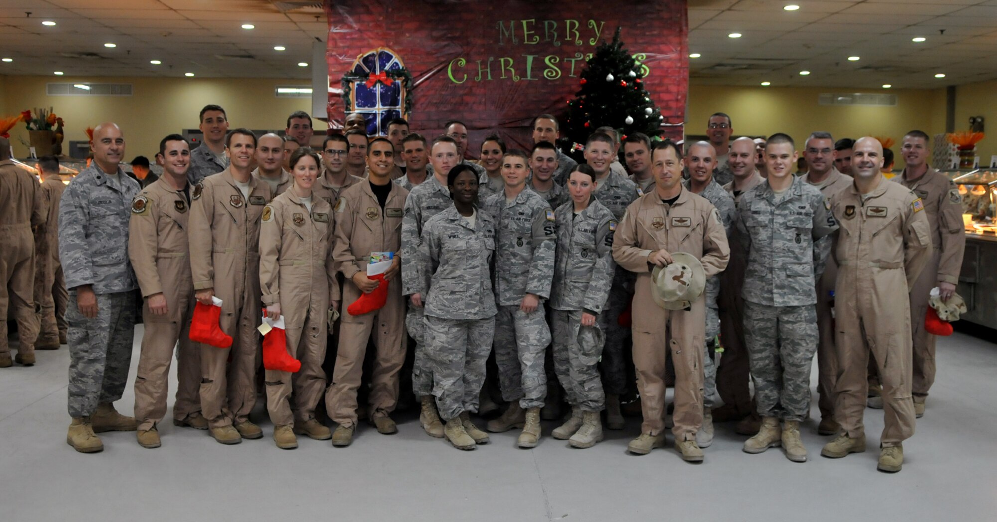 SOUTHWEST ASIA -- Col. Chad Manske, 100th Air Refueling Wing commander, and Chaplain (Lt. Col.) Frederick Viccellio, met with members of the 100th ARW deployed to the Middle East during a holiday visit Dec. 18.  The colonels took stockings full of gifts provided by the RAF Mildenhall chapel's Single Airman's Ministry and various volunteers. (U.S. Air Force photo by Staff Sgt. Austin M. May)