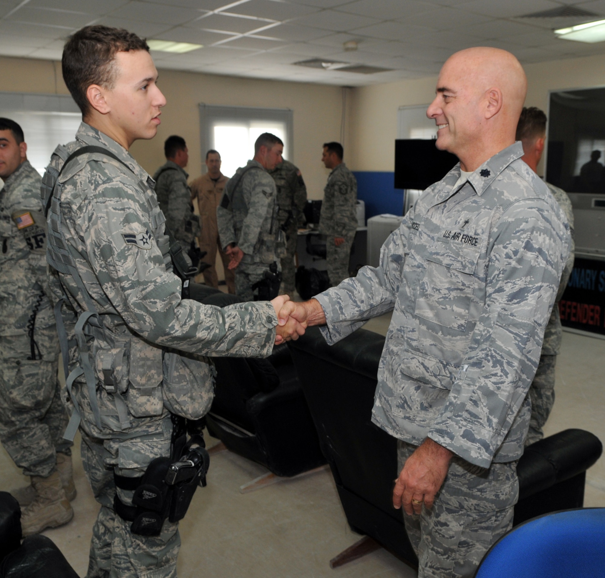 SOUTHWEST ASIA -- Chaplain (Lt. Col.) Frederick Viccellio, 100th Air Refueling Wing chaplain, greets members of the 379th Expeditionary Security Forces Squadron deployed from RAF Mildenhall during a visit Dec. 18.  Chaplain Viccellio travelled with Col. Chad Manske, 100th ARW commander, to the Middle East to hand deliver treats and encouragement during the holidays. (U.S. Air Force photo by Staff Sgt. Austin M. May)