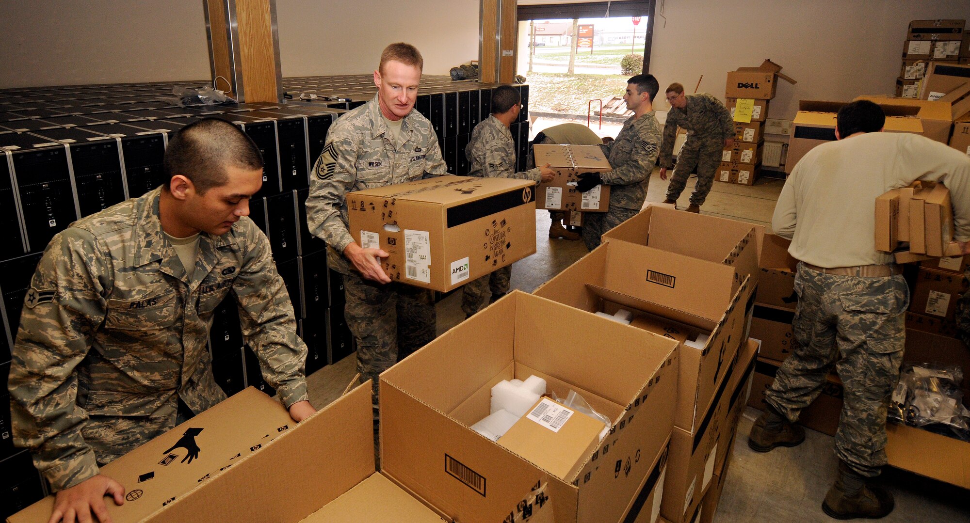 SPANGDALEM AIR BASE, Germany – Members of the 52nd Communications Squadron and 52nd Mission Support Group unload pallets of computer boxes and form an assembly line to unpack them Dec. 18 in the 52nd CS facility, Bldg. 107. More than 2,400 new computers were delivered to the 52nd Fighter Wing as part of a $1.2 million project to ensure compliance with the Federal Desktop Core Configuration. All wing computers are required to have the new FDCC before June 30. (U.S. Air Force photo/Senior Airman Benjamin Wilson)