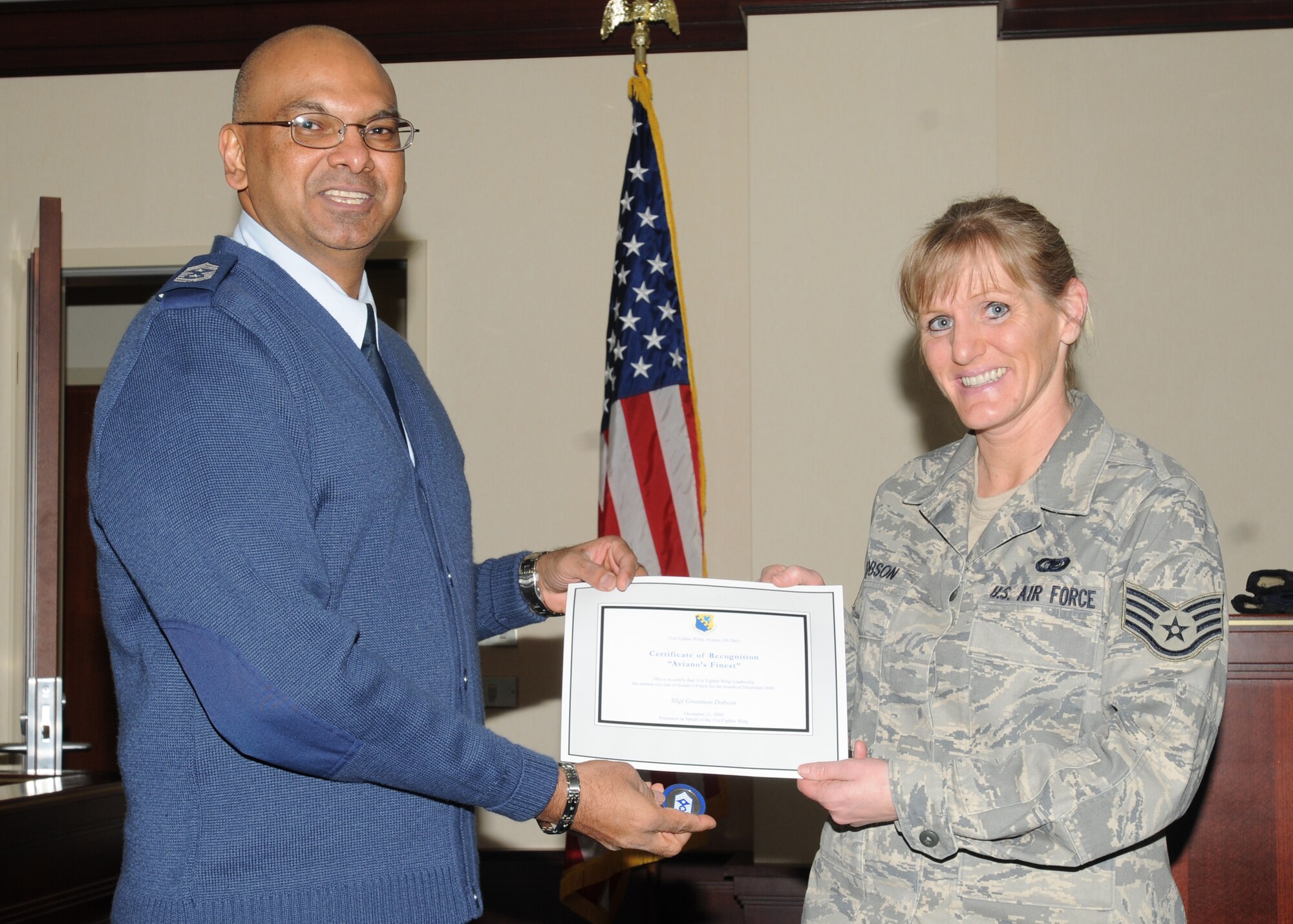 Chief Master Sgt. Laten Williams, 31st Fighter Wing command chief, congratulates Staff Sgt.Gwennan Dobson, 31st Fighter Wing Legal Office, on her selection as one of Aviano's Finest (U.S. Air Force photo/Airman LaVel Sterling)