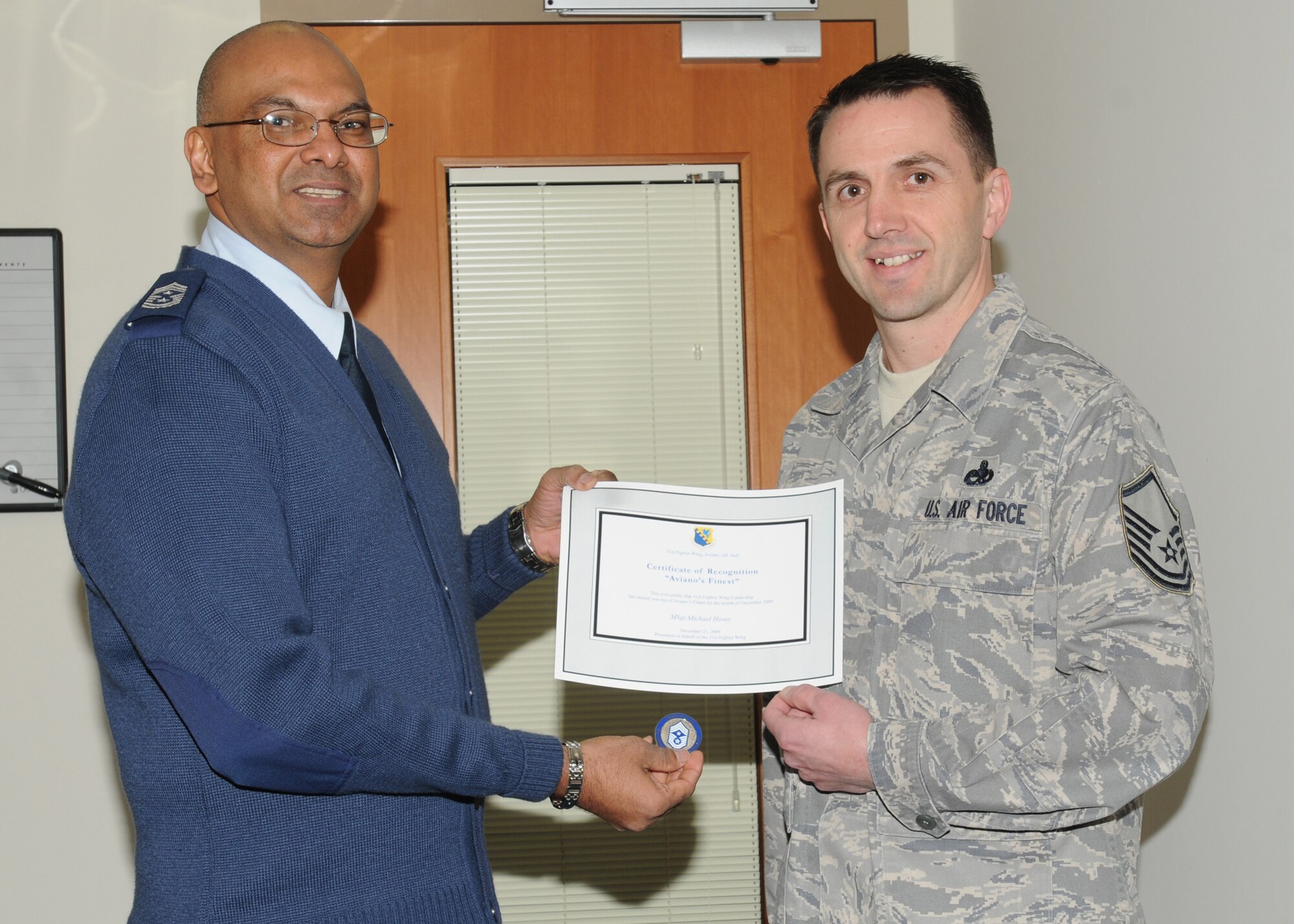 Chief Master Sgt. Laten Williams, 31st Fighter Wing command chief, congratulates MSgt Michael Hovey, 31 Fighter Wing Security Office, on his selection as one of Aviano's Finest(U.S. Air Force photo/Airman LaVel Sterling)
