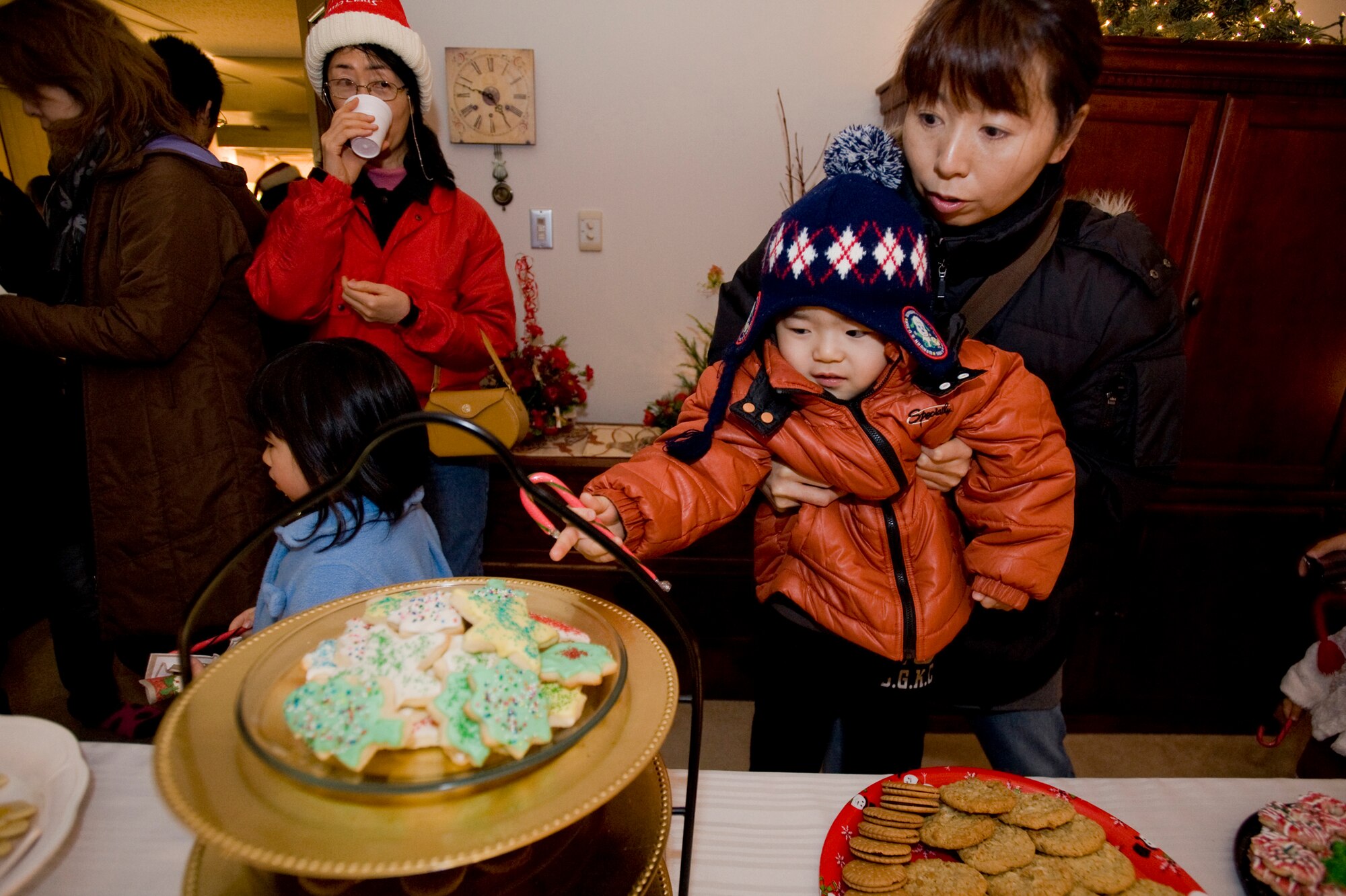 MISAWA AIR BASE, Japan -- Children and adults from the local community visit Misawa Air Base Dec. 19 during the annual Christmas Lights Tour. The tour consisted of a stop at the wing commander's house and a bus ride around base to view Christmas lights and decorations. The night ended with a Christmas celebration at Sollars Elementary School where Japanese guests helped themselves to hot chocolate, while children played games and met Santa Claus. (U.S. Air Force photo/Senior Airman Jamal D. Sutter)