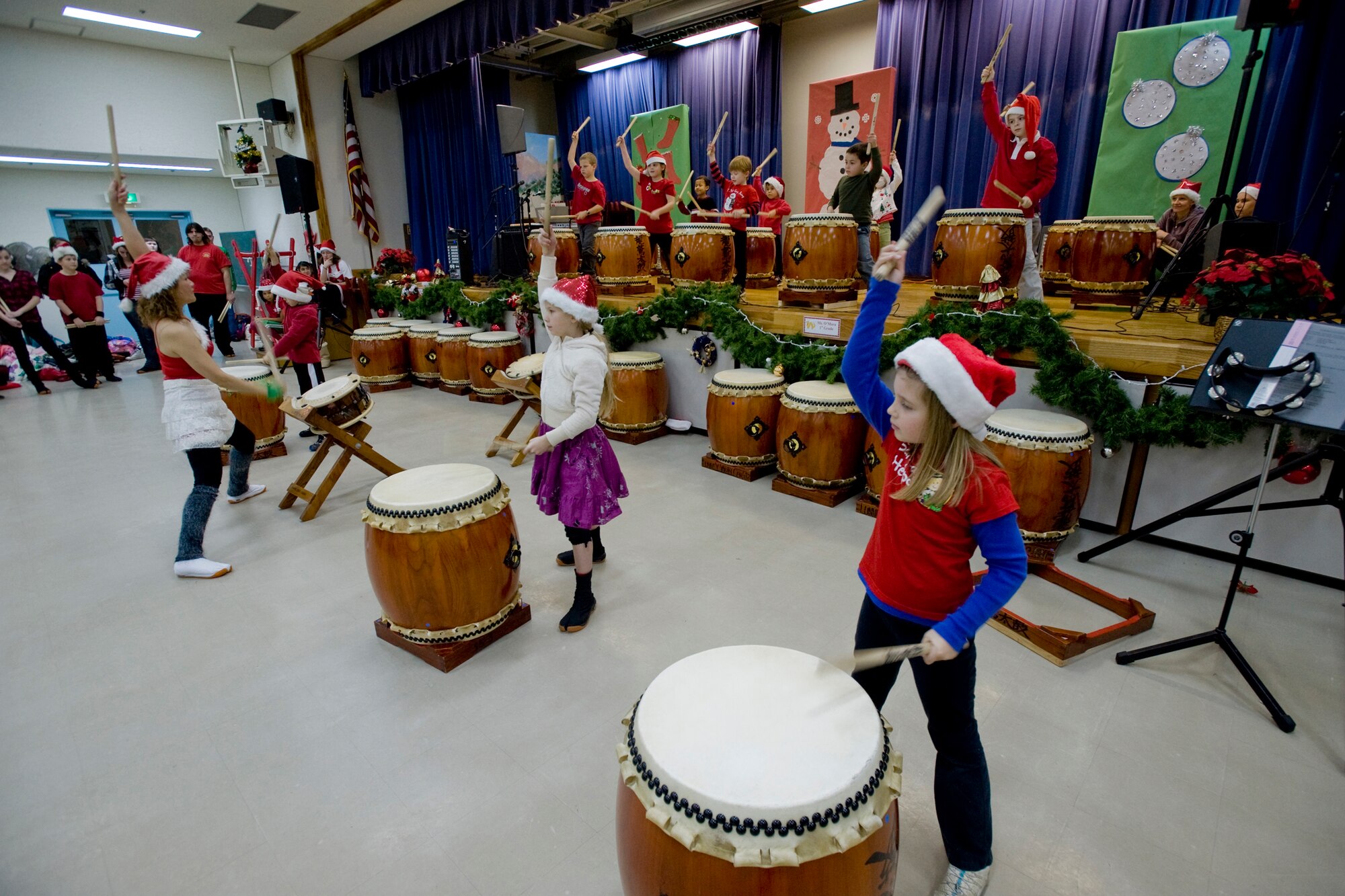 MISAWA AIR BASE, Japan -- Students from the base schools play Taiko drums during a performance Dec. 19 at Sollars Elementary School. The performance was part of a Christmas celebration which brought more than 400 Japanese guests on base. (U.S. Air Force photo/Senior Airman Jamal D. Sutter)