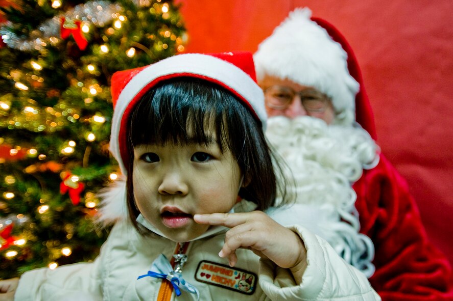 MISAWA AIR BASE, Japan -- A young girl from the local community meets Santa Claus Dec. 19 at Sollars Elementary School. For many of the Japanese children, it was their first time meeting Santa. (U.S. Air Force photo/Senior Airman Jamal D. Sutter)