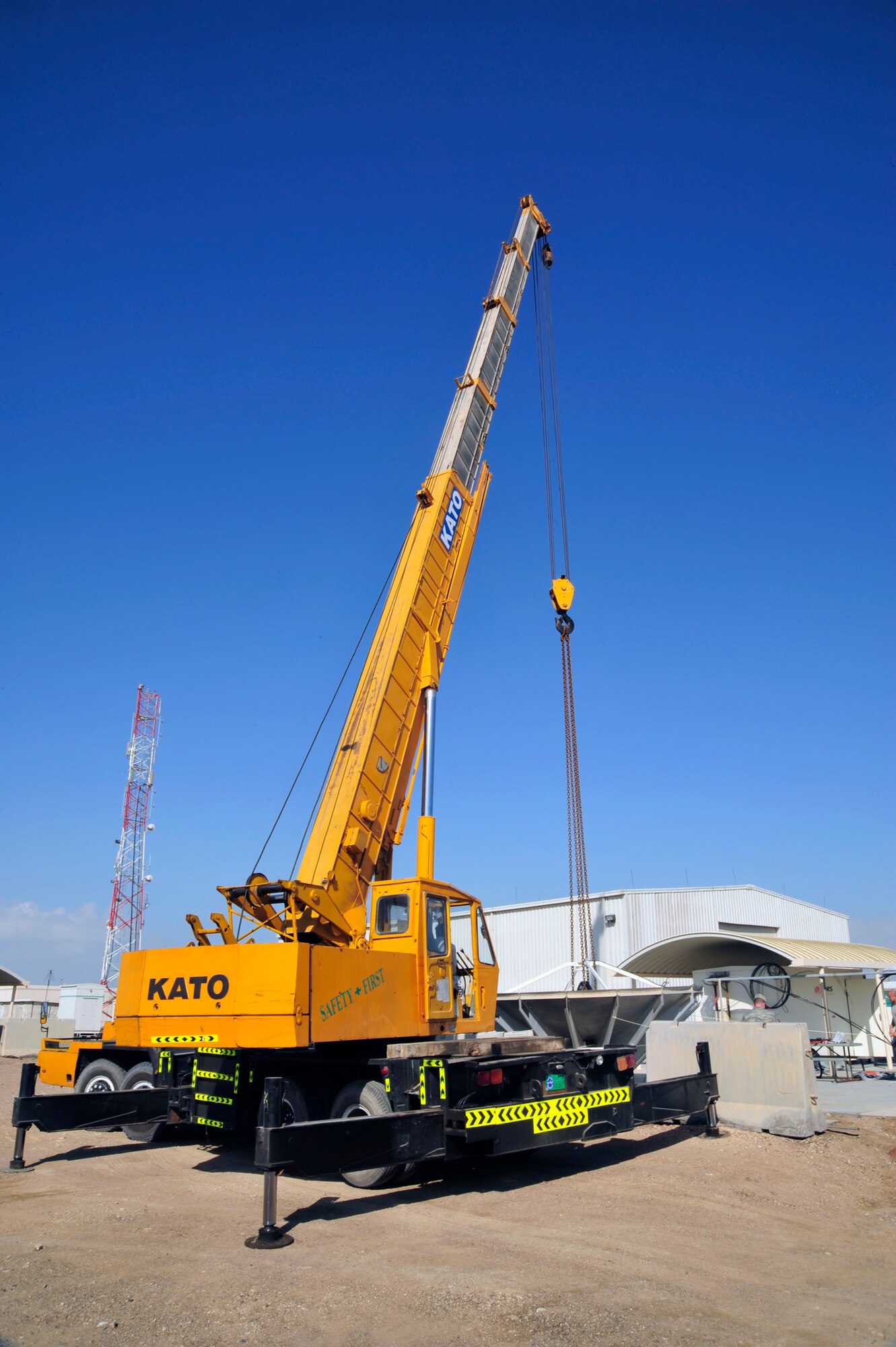 SOUTHWEST ASIA – The 380th Expeditionary Communications Squadron repositions a satellite dish using a crane Dec. 21, 2009. The dish was relocated to allow 380th ECS Airmen and contractors to rotate the pedestal in order to increase satellite signal reception. (U.S. Air Force photo/Tech. Sgt. Charles Larkin Sr)