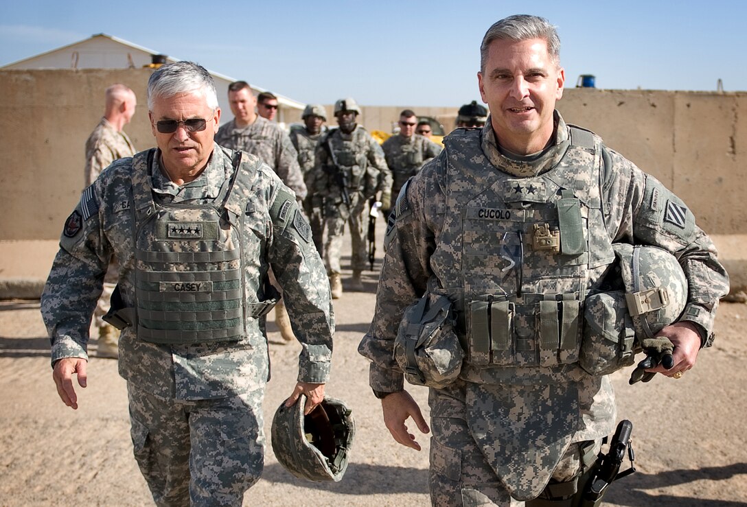 U.S. Army Chief of Staff Gen. George W. Casey Jr., left, and U.S. Army Maj. Gen. Tony Cucolo, right, commander of the 3rd Infantry Division, walk through Ramadi, Iraq, Dec. 20, 2009.