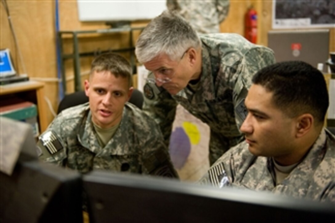 Sgt. 1st Class Russell Blackwell shows the Chief of Staff of the Army Gen. George W. Casey Jr. current operations in the tactical operational center in Ramadi, Iraq, on Dec. 20, 2009.  