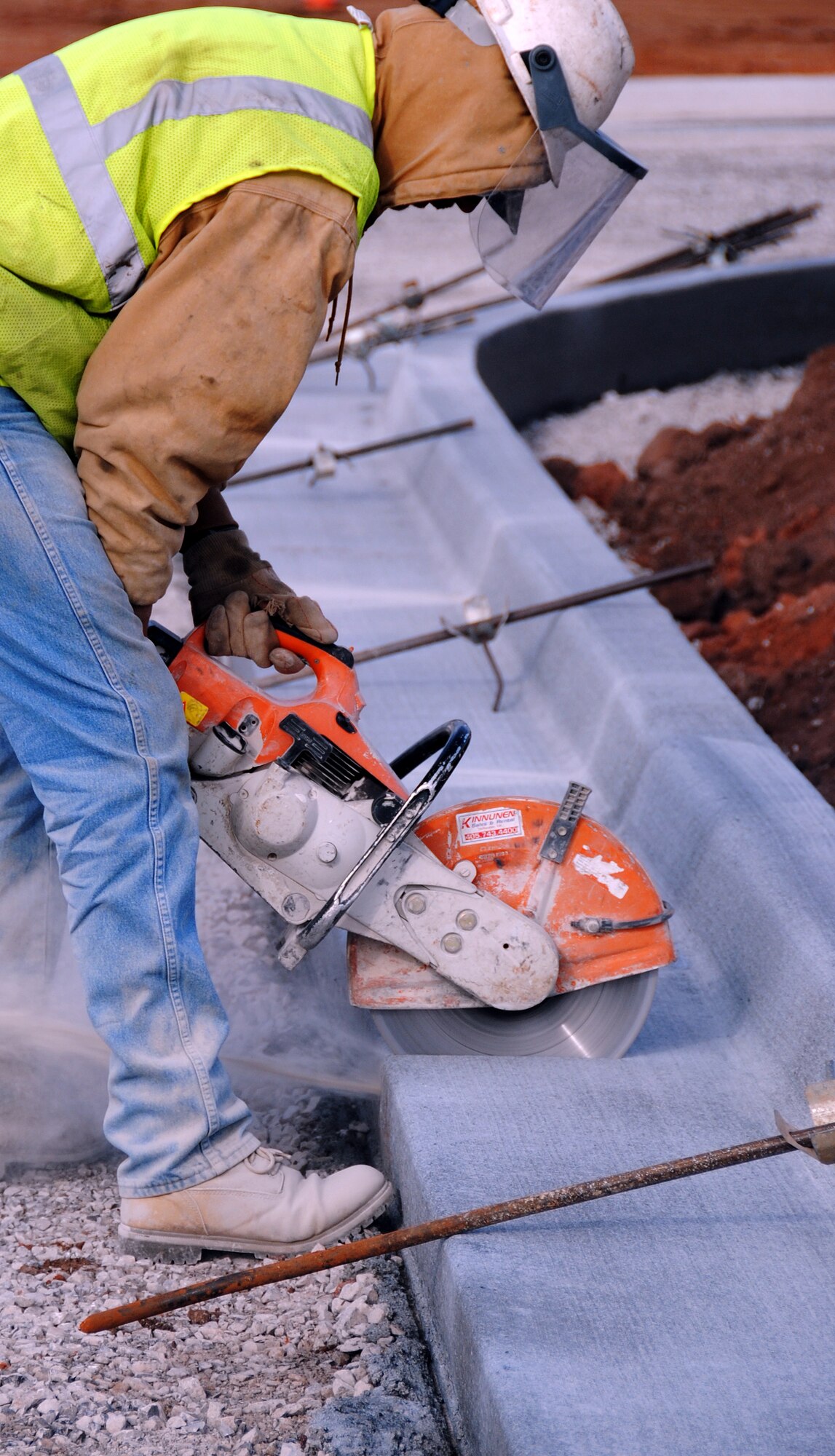 A worker cuts expansion joints into curbing at the Armed Forces Reserve Center under construction on the south end of Vance AFB. The contractor, TCI Architects/Engineers/Contractor, Inc., from La Crosse, Wis., began work on the $20 million project July 14, with a scheduled completion date of Oct. 27, 2010. The reserve center will include a 60,000 square-foot training building and a 9,000 square-foot operations maintenance building that will be used by Soldiers with the Army Reserve and Oklahoma Army National Guard. (U.S. Air Force photo/ Joe B. Wiles)