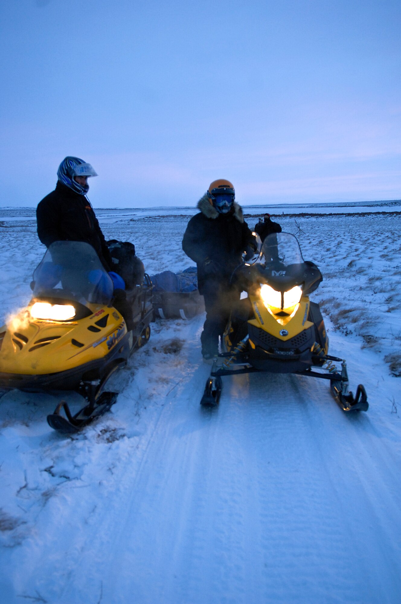 KOTZEBUE, Alaska -- D Company (-) Anti-Terrorism Battalion, 4th Marine Division members assigned to Elmendorf Air Force Base, Alaska and their guide Brad Reich, Mayor of Kiana, Alaska travel by snow machine to deliver toys from the Toys for Tots program Dec. 17. This is the first time in the past 15 years that the Marines have personally delivered toys to the Kotzebue region. (U.S. Air Force photo/Airman 1st Class Jack Sanders)

