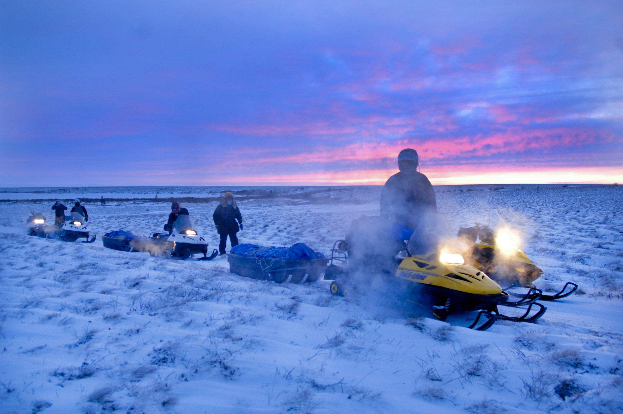 KOTZEBUE, Alaska -- D Company (-) Anti-Terrorism Battalion, 4th Marine Division members assigned to Elmendorf Air Force Base, Alaska and their guide Brad Reich, Mayor of Kiana, Alaska travel by snow machine to deliver toys from the Toys for Tots program Dec. 17. The team endured rough terrain and temperatures averaging negative 30 degrees during the trip. (U.S. Air Force photo/Airman 1st Class Jack Sanders)
