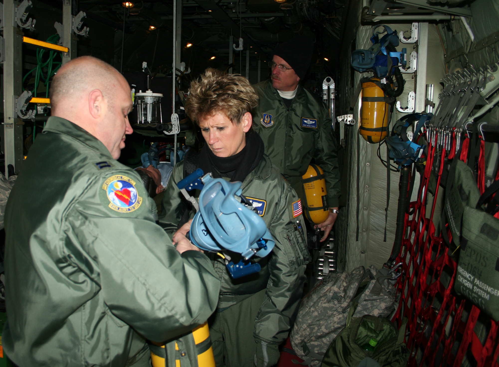 WRIGHT-PATTERSON AIR FORCE BASE, Ohio - Maj. Kimberlee Sandusky and Capt. Christopher Blomberg, both from the 445th Aeromedical Evacuation Squadron, inspect flight gear for an AES training flight Dec. 16. Members of the 445th Aeromedical Evacuation Squadron are ready to fill the need when events like natural disasters, war or routine medical transportation by air is required. (U.S. Air Force photo/Senior Airman Matthew Cook)