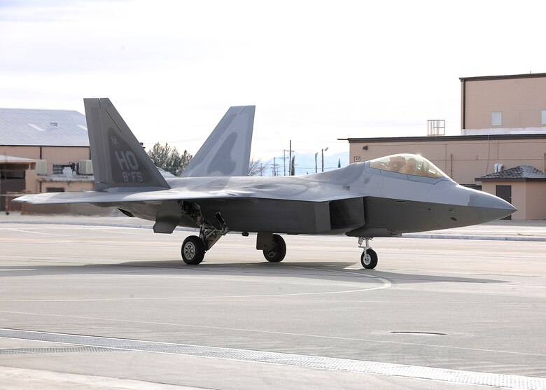 Lt. Col. Craig Baker taxis Dec. 21, 2009, the first F-22 Raptor assigned to the 8th Fighter Squdaron into a hangar at Holloman Air Force Base, N.M. The pilots and maintainers of the 8th FS will work hand-in-hand with the 7th Fighter Squadron until the unit deploys next summer. Colonel Baker is the 8th Fighter Squadron commander. (U.S. Air Force photo/Senior Airman John D. Strong II)
