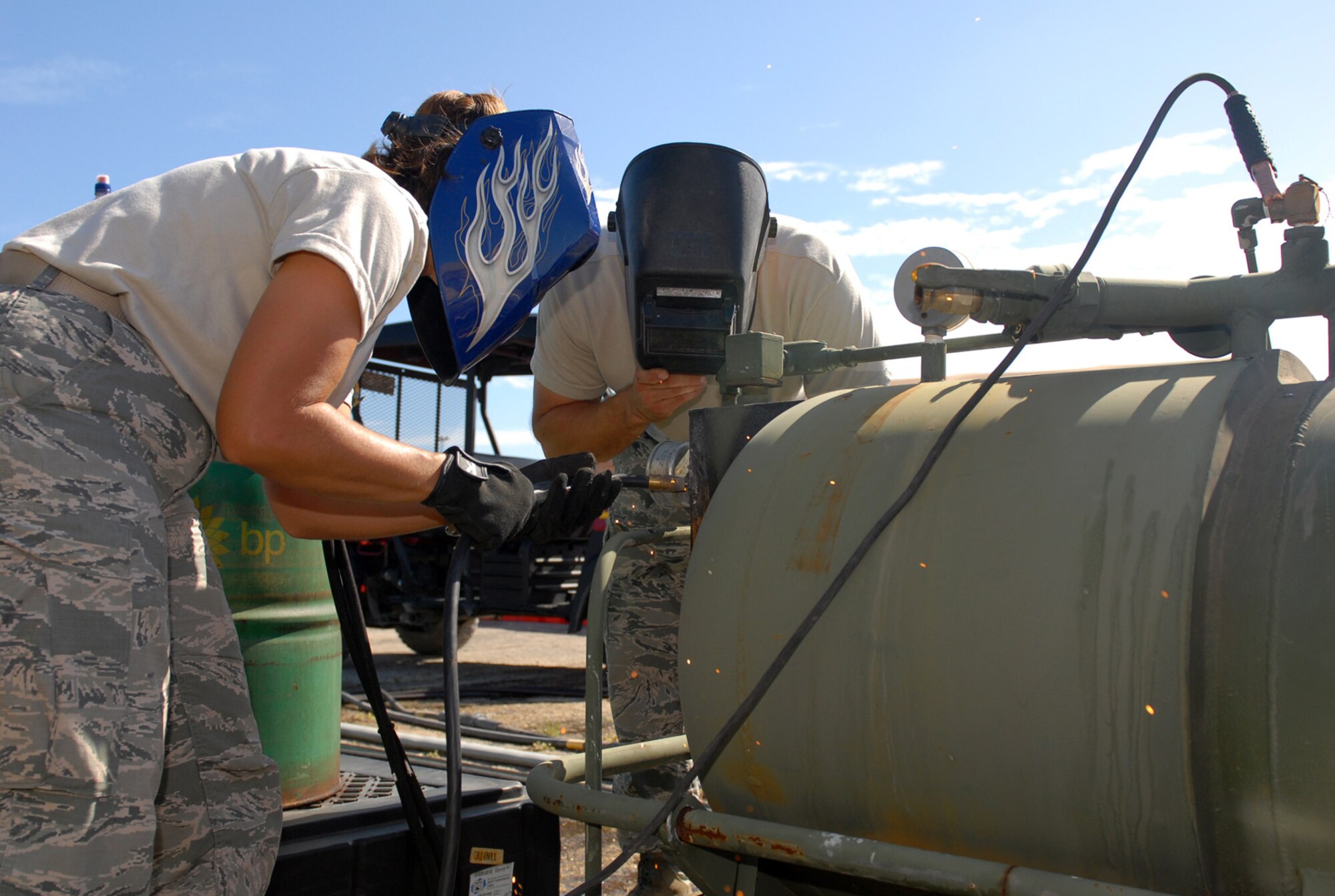 Senior Airman JoAnne M. Lewis and Master Sgt. Ronnie J. Piovesan, both members of the Arkansas Air National Guard's 188th Fighter Wing Civil Engineering Squadron, repair a water boiler Dec. 16, 2009, at Camp Justice in Guantanamo Bay, Cuba. Approximately 50 members of the 188th are deployed to Guantanamo Bay. During the deployment, the 188th CES is attached to Joint Task Force Guantanamo's 474th Expeditionary Civil Engineering Squadron. (JTF Guantanamo photo by Army Spc. Cody Black) 