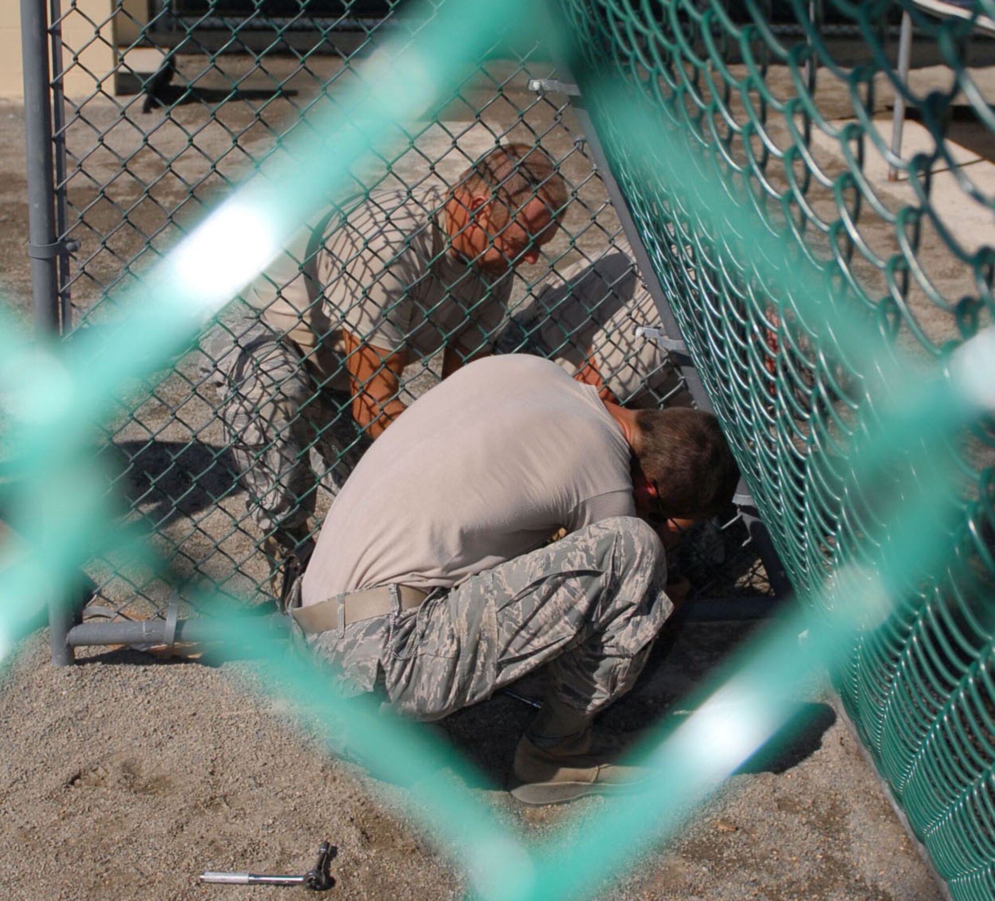 Members of the Arkansas Air National Guard's 188th Fighter Wing, currently deployed to Joint Task Force Guantanamo's 474th Expeditionary Civil Engineering Squadron, complete the installation of soccer goals for detainees inside the recreation yard of Camp 6, Dec. 8, 2009. The 474th ECES supports JTF Guantanamo by maintaining the Expeditionary Legal Complex and Camp Justice facilities and infrastructure, along with detention facility improvements. (JTF Guantanamo photo by Army Spc. Cody Black) 