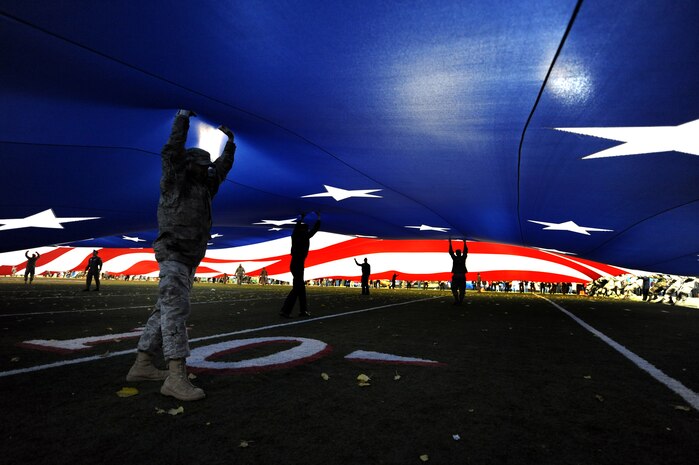 LAS VEGAS -- Airmen from Nellis and Creech Air Force Bases hold up the American flag at the MAACO Las Vegas Bowl at Sam Boyd Stadium, Dec. 22.(U.S. Air Force photo by Airman 1st Class Brett Clashman)      
