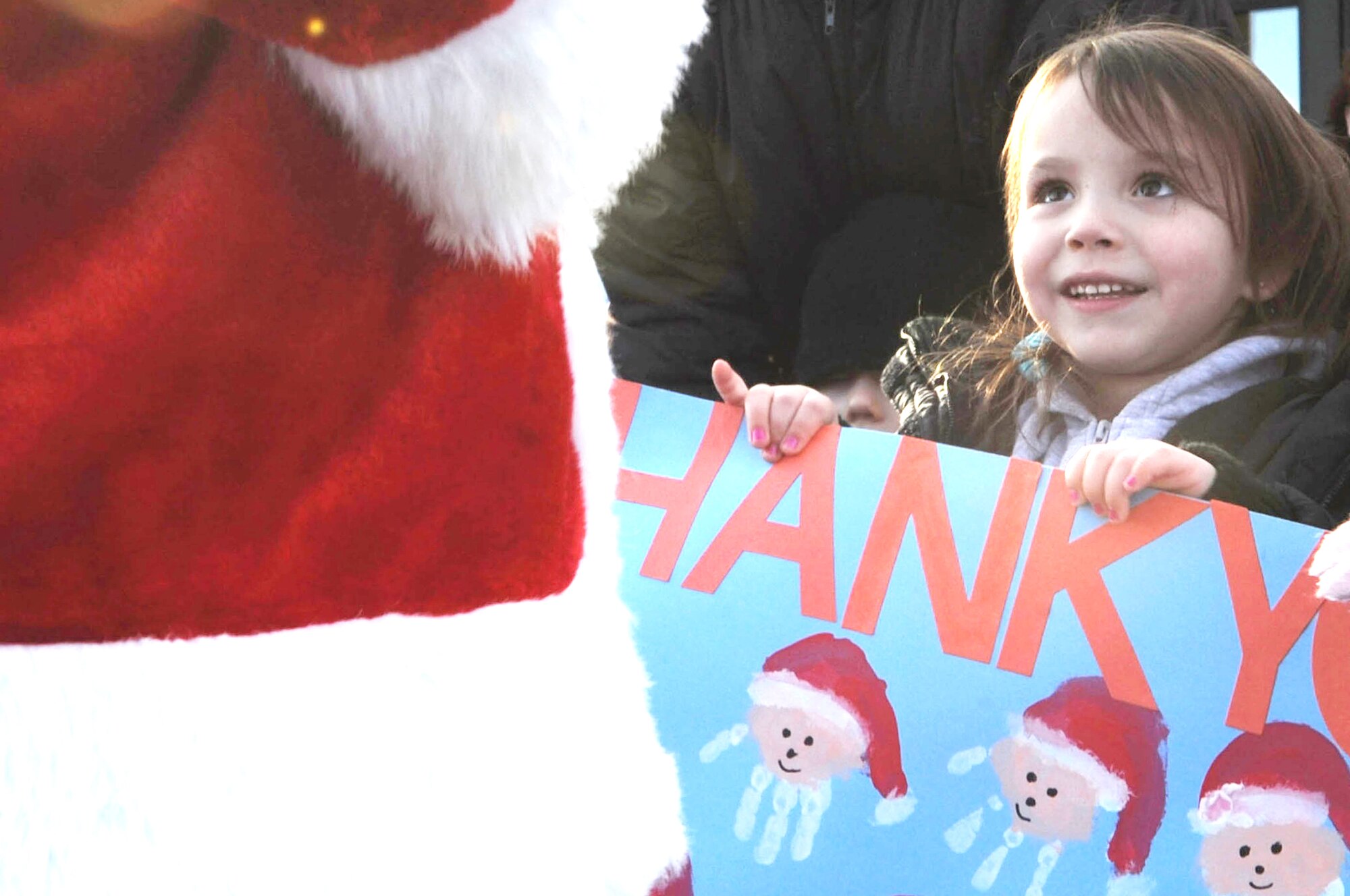 A child enrolled in the Youth and Family Services child care center smiles in excitement while seeing Santa Dec. 17, 2009, in Rapid City, S.D. This is the third time Santa, Mrs. Claus and Airmen from Ellsworth Air Force Base, S.D., bought, wrapped and delivered gifts for every child at the center. (U.S. Air Force photo/Airman 1st Class Corey Hook)