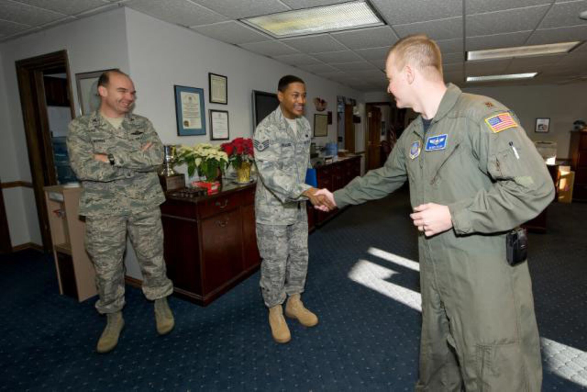 Major Derek Salmi, 436th Airlift Wing executive officer, congratulates Staff Sgt. Philip Palacios 436th Airlift Wing non-commissioned officer in charge of protocol, after he is presented with the STEP promotion to Tech. Sgt. by Col. Manson Morris, 436th Airlift Wing Commander. 