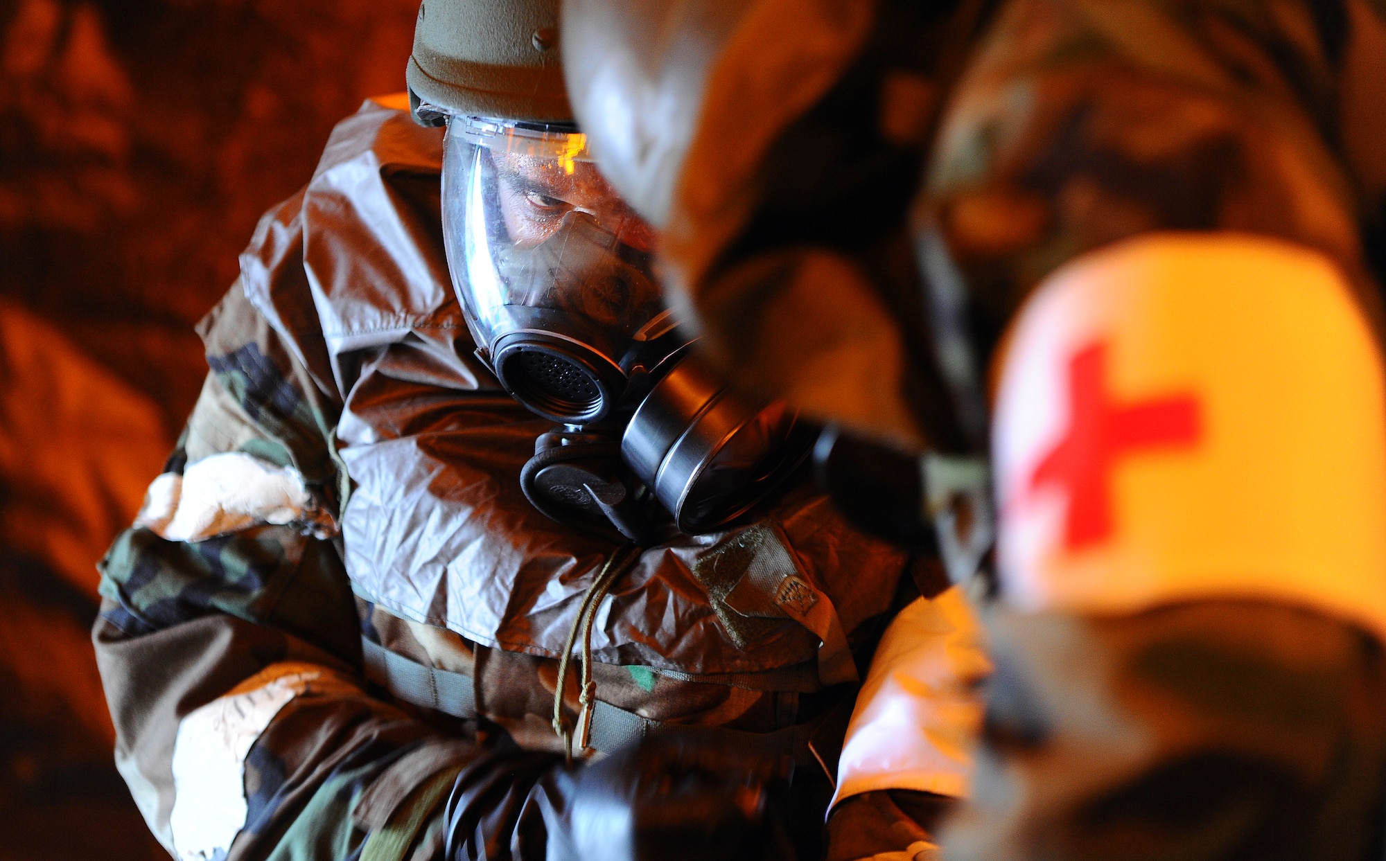 OFFUTT AIR FORCE BASE Neb. - Senior Airman Christopher Buttone quickly performs a "buddy check" on Staff Sgt. Juan Rogelio, both from the 55th Medical Group, to ensure a proper fit on his chemical suit as Airmen in the Medical Group tent fall under a mock chemical attack during an Operational Readiness Inspection Sept. 12.  The 55th Wing scored an ?Excellent? rating during this routine inspection which tested their combat skills and ability to effectively protect a deployed base from attack. U.S. Air Force Photo by Josh Plueger