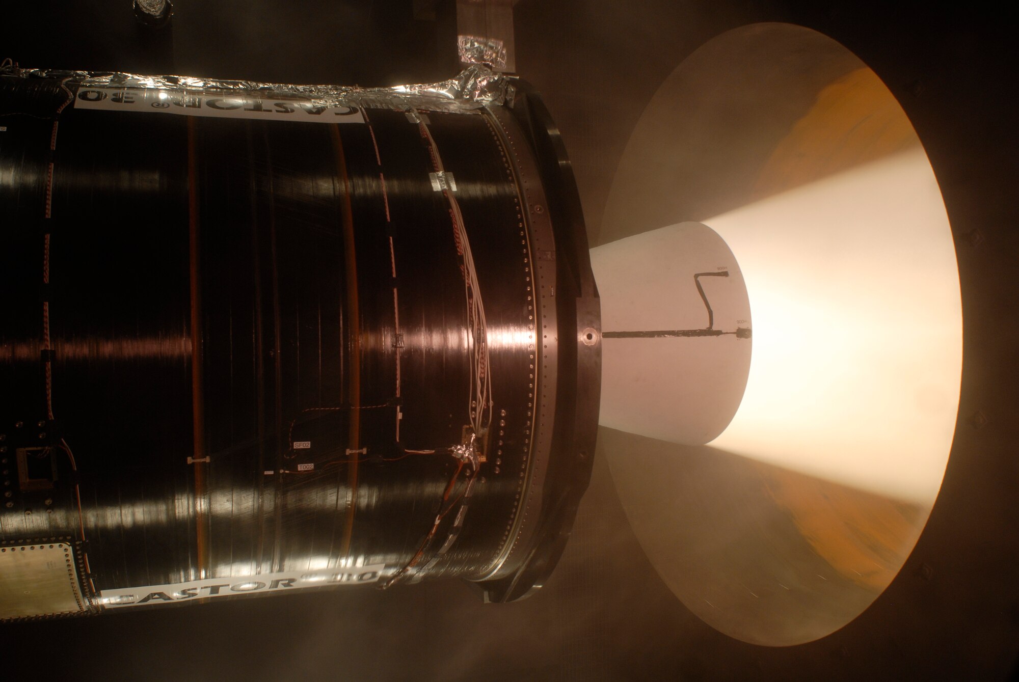 A Castor 30 rocket motor was ground-tested Dec. 9, 2009, at the Arnold Engineering Development Center at Arnold Air Force Base, Tenn., in a specialized vacuum chamber that simulates the altitude at which the upper-stage motor will operate. This was the longest rocket-motor test ever in AEDC's J-6 Large Rocket Motor Test Facility, which became operational in 1994. (U.S. Air Force photo/Rick Goodfriend)