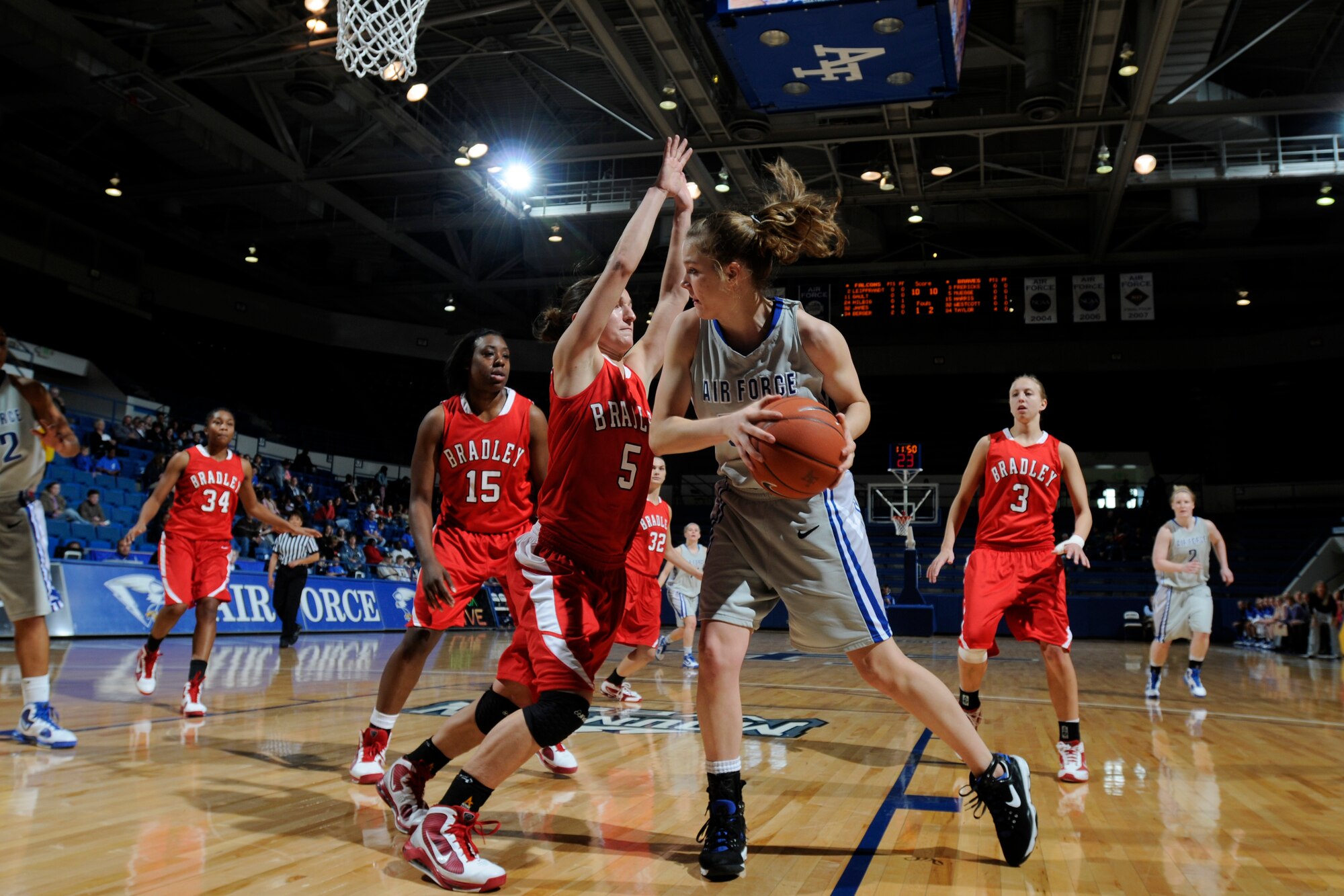 Falcons freshman forward Katie Hilbig pushes toward the basket as the Braves' Hanna Muegge defends during the Air Force-Bradley game at the Air Force Academy's Clune Arena Dec. 19, 2009. Hilbig, a native of Castle Rock, Colo., had two rebounds in the Falcons' 62-45 loss. (U.S. Air Force photo/J. Rachel Spencer)