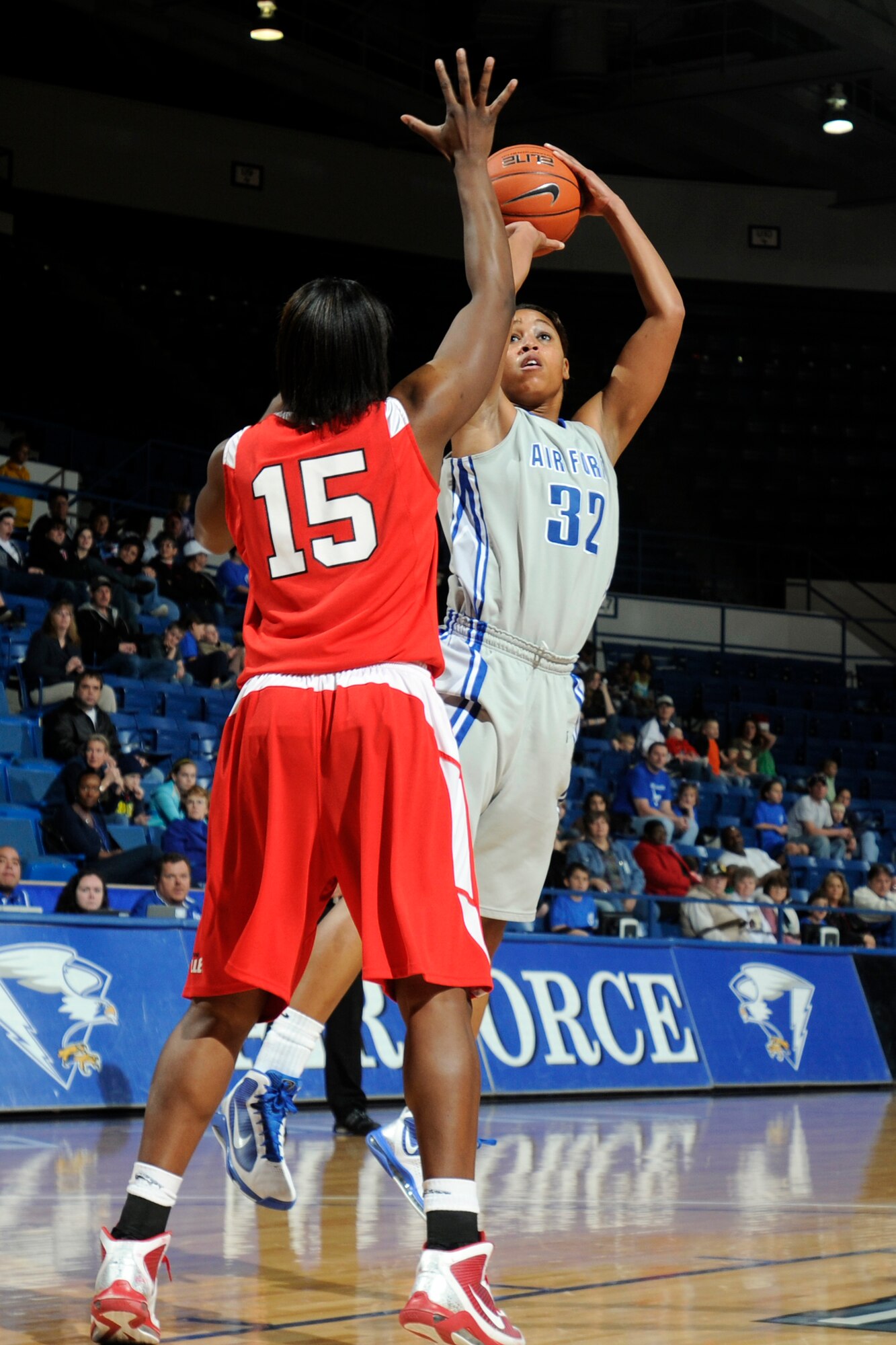 Falcons freshman forward Dymond James takes a jump shot as Braves junior forward Sonya Harris attempts to block during the Air Force-Bradley game at the Air Force Academy's Clune Arena Dec. 19, 2009. James, a native of Brambleton, Va., had a career-high 10 points and seven rebounds in the Falcons' 62-45 loss. (U.S. Air Force photo/J. Rachel Spencer)