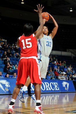 Falcons freshman forward Dymond James takes a jump shot as Braves junior forward Sonya Harris attempts to block during the Air Force-Bradley game at the Air Force Academy's Clune Arena Dec. 19, 2009. James, a native of Brambleton, Va., had a career-high 10 points and seven rebounds in the Falcons' 62-45 loss. (U.S. Air Force photo/J. Rachel Spencer)