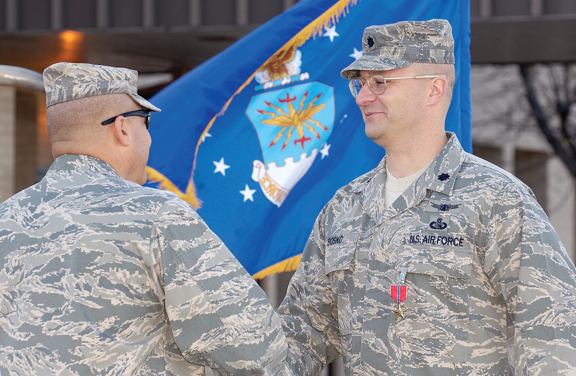 Lt. Col. David Bosko is congratulated after being presented the Bronze Star by 3rd Combat Communications Group Commander Col. Thomas Byrge Jr. during a recent ceremony in front of the group’s Airmen. Colonel Bosko, deputy commander of the 3rd Herd, earned the medal for his leadership in establishing combat communications during hostile actions in Afghanistan from September 2008 to March 2009. He directed the largest communications capability increase in the 455th Air Expeditionary Wing’s history and supported Joint, Army and Coalition forces. (Air Force photo by Margo Wright)

