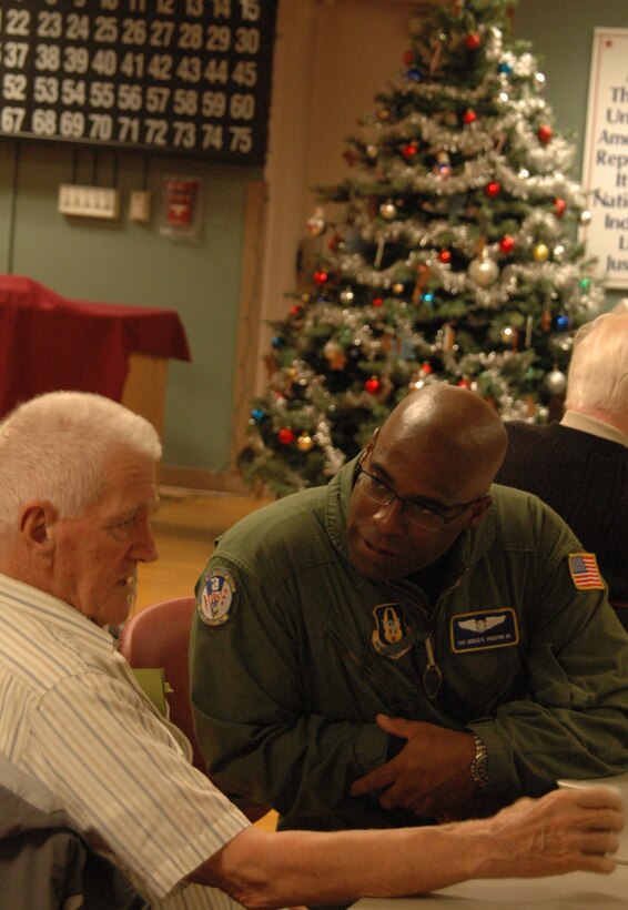 Tech. Sgt. Gerald Overton, a C-5 flight engineer with the 337th Airlift Squadron at Westover Air Reserve Base, talks with a veteran at the Soldiers Home in Holyoke, Mass., Dec. 18. Sergeant Overton was among more than 30 Airmen from Westover who spent part of the morning visiting with the veterans. (US Air Force photo/Tech. Sgt. Andrew Biscoe)