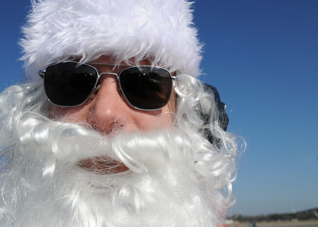 Maj. Aaron Sasson waits on the flightline here Dec. 22 to marshal in a Charleston AFB C-17 as Santa Claus. Major Sasson was voted to dress up by the 437th Aircraft Maintenance Squadron for a squadron booster club fundraiser. Major Sasson is the 437 AMXS operations officer. (U.S. Air Force photo/Senior Airman Katie Gieratz)(RELEASED)
