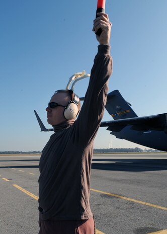 Maj. Jonathan Downing marshals in a Charleston AFB C-17 on the flightline here Dec. 22. The 437th Aircraft Maintenance Squadron voted for Major Downing to dress up as a reindeer while marshalling an aircraft for a booster club fundraiser which raised $800. Major Downing is the 437 AMXS commander. (U.S. Air Force photo/Senior Airman Katie Gieratz)(RELEASED)