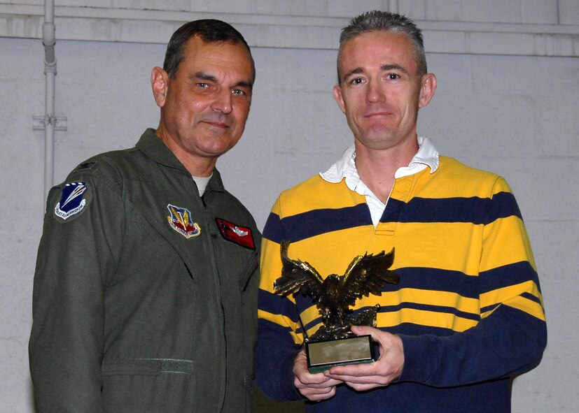 Master Sgt  Curtis Hanock, 131LRS, Outstanding Senior NCO of the Year 2009, receives an Eagle trophy from Col Robert Leeker, 131st Bomb Wing commander, during the 131st Outstanding Airman of the Year awards on Dec 6 at Lambert-Saint Louis ANGB..  (Air Force Photo by Master Sgt Mary-Dale Amison   RELEASED)
 