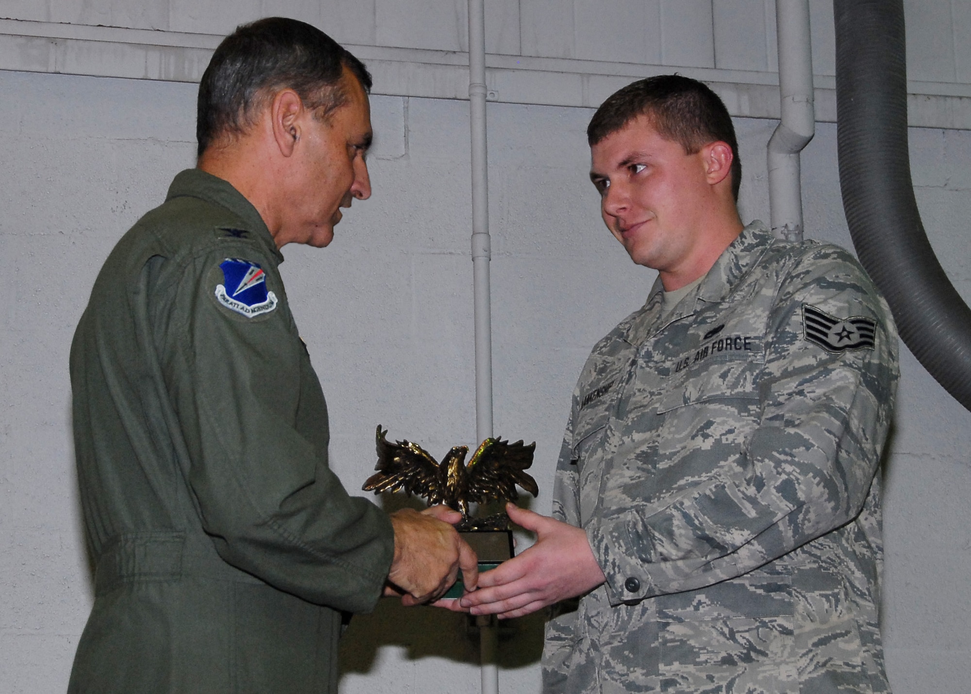Tech Sgt William Blankenship, 239CBCS, Outstanding NCO of the Year 2009, receives an Eagle trophy from Col Robert Leeker, 131st Bomb Wing commander, during the 131st Outstanding Airman of the Year awards on Dec 6 at Lambert-Saint Louis ANGB..  (Air Force Photo by Master Sgt Mary-Dale Amison   RELEASED)
 