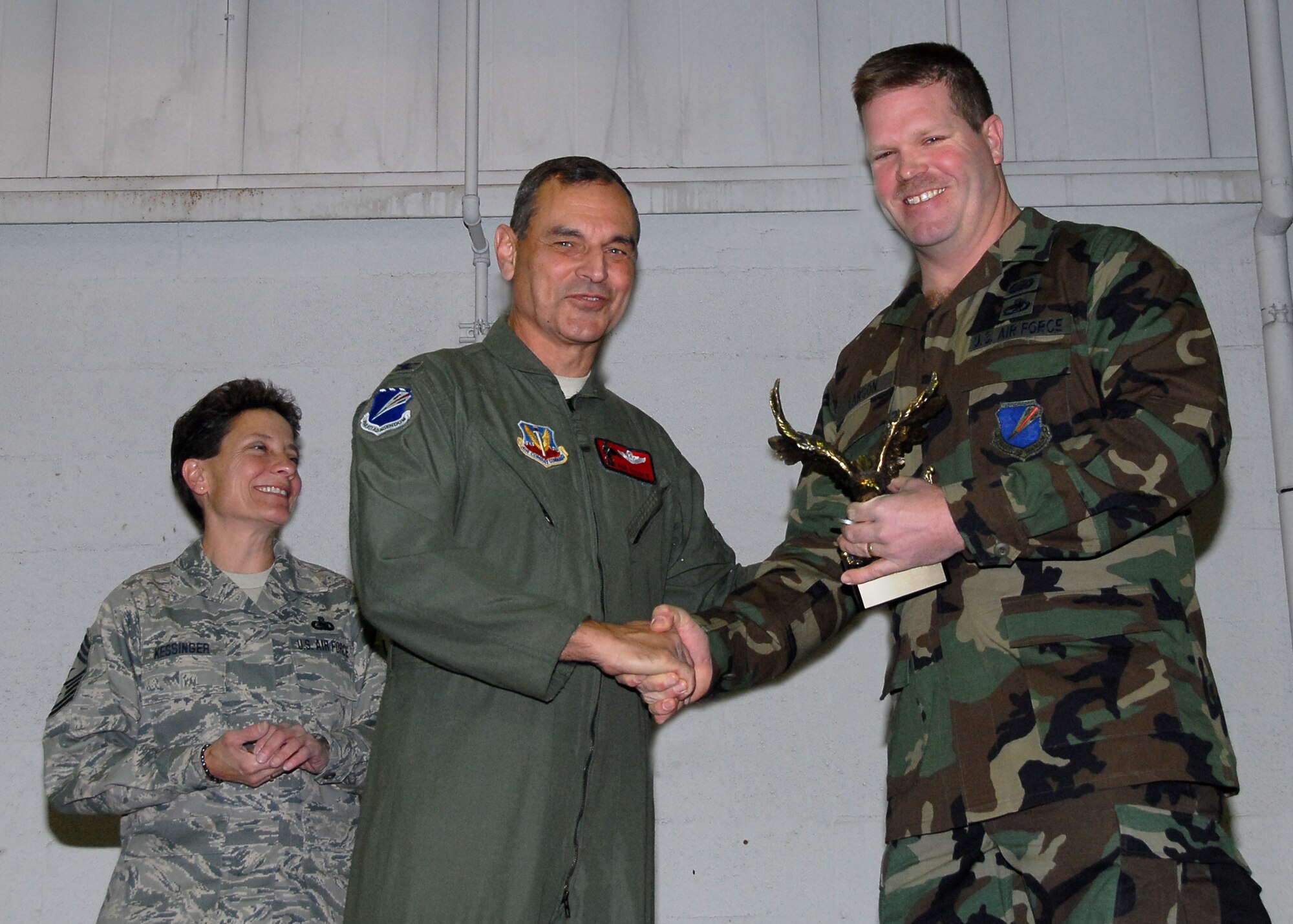 First Lieutenant Chad Larson, 131FSS, receives an Eagle trophy from Col Robert Leeker, 131st Bomb Wing commander, during the 131st Outstanding Airman of the Year awards on Dec 6 at Lambert-Saint Louis ANGB.  Larson was recognized for his contributions to Lambert ANGB to Whiteman AFB transition efforts.  (Air Force Photo by Master Sgt Mary-Dale Amison   RELEASED)
 