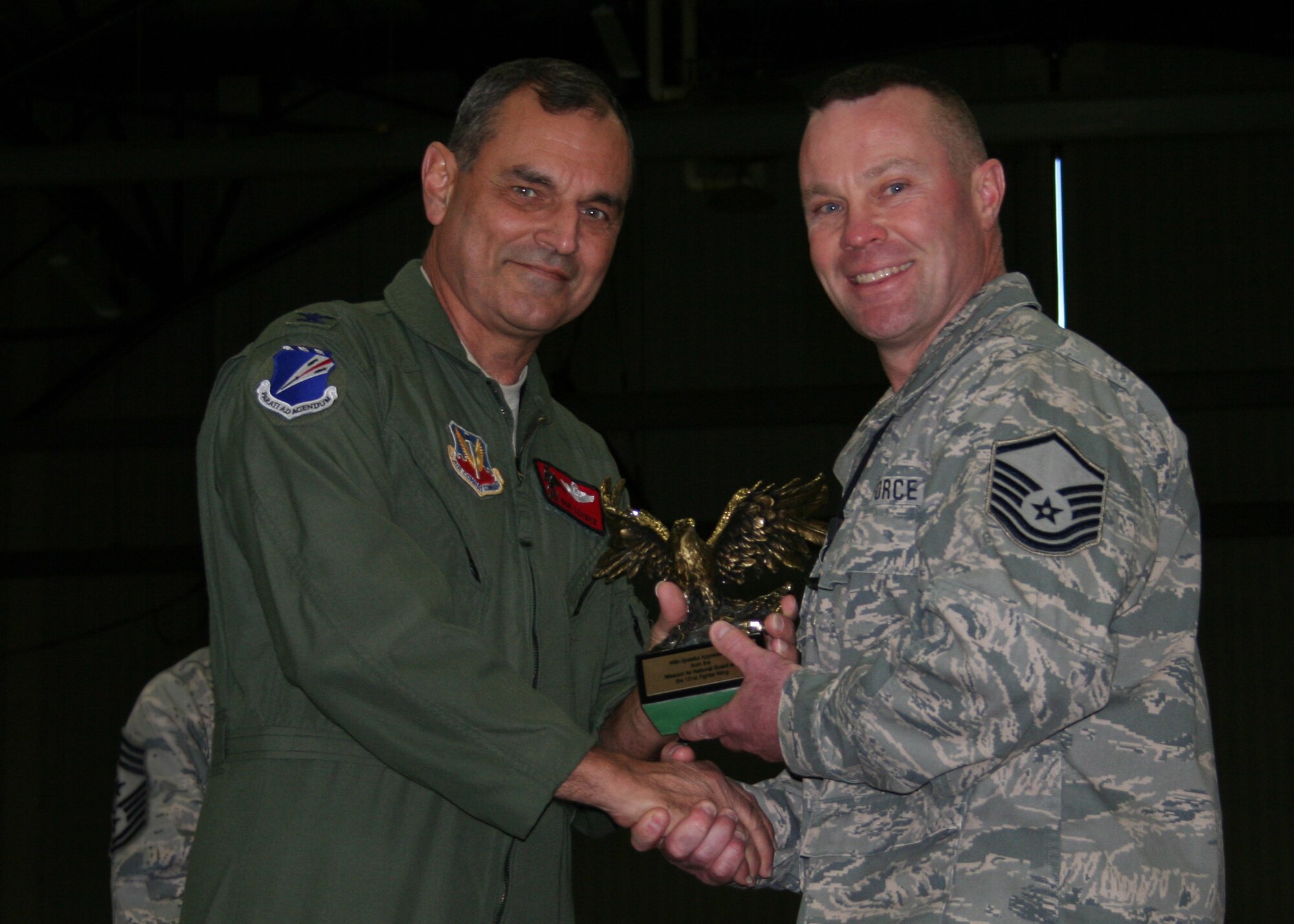 Master Sgt Ken Huff, 131AMXS, receives an Eagle trophy from Col Robert Leeker, 131st Bomb Wing commander, during the 131st Outstanding Airman of the Year awards on Dec 5 at Whiteman Air Force Base.  Huff was recognized for his contributions to Lambert ANGB to Whiteman AFB transition efforts.  (Air Force Photo by Tech Sgt Chris Boehlein   RELEASED)
 