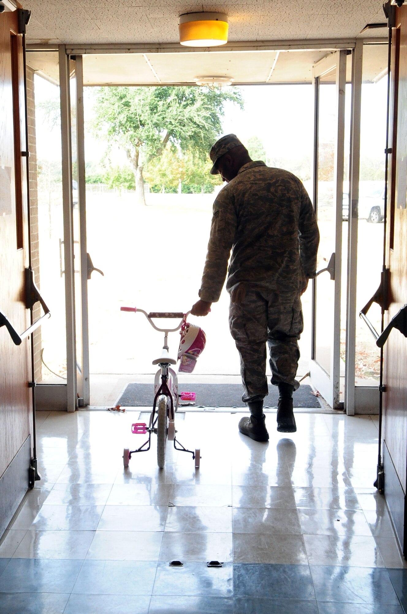 BARKSDALE AIR FORCE BASE, La. – Senior Airman Marcus Guillory, 2d Logistics Readiness Squadron, wheels a Huffy bicycle out of the Chapel 2 Annex, Dec. 22. Airmen Guillory received the bicycle and other gifts for his children from the secret Santa giveaway which gave military families the chance to subsidize their gift budget. (U.S. Air Force photo by Senior Airman Joanna M. Kresge)