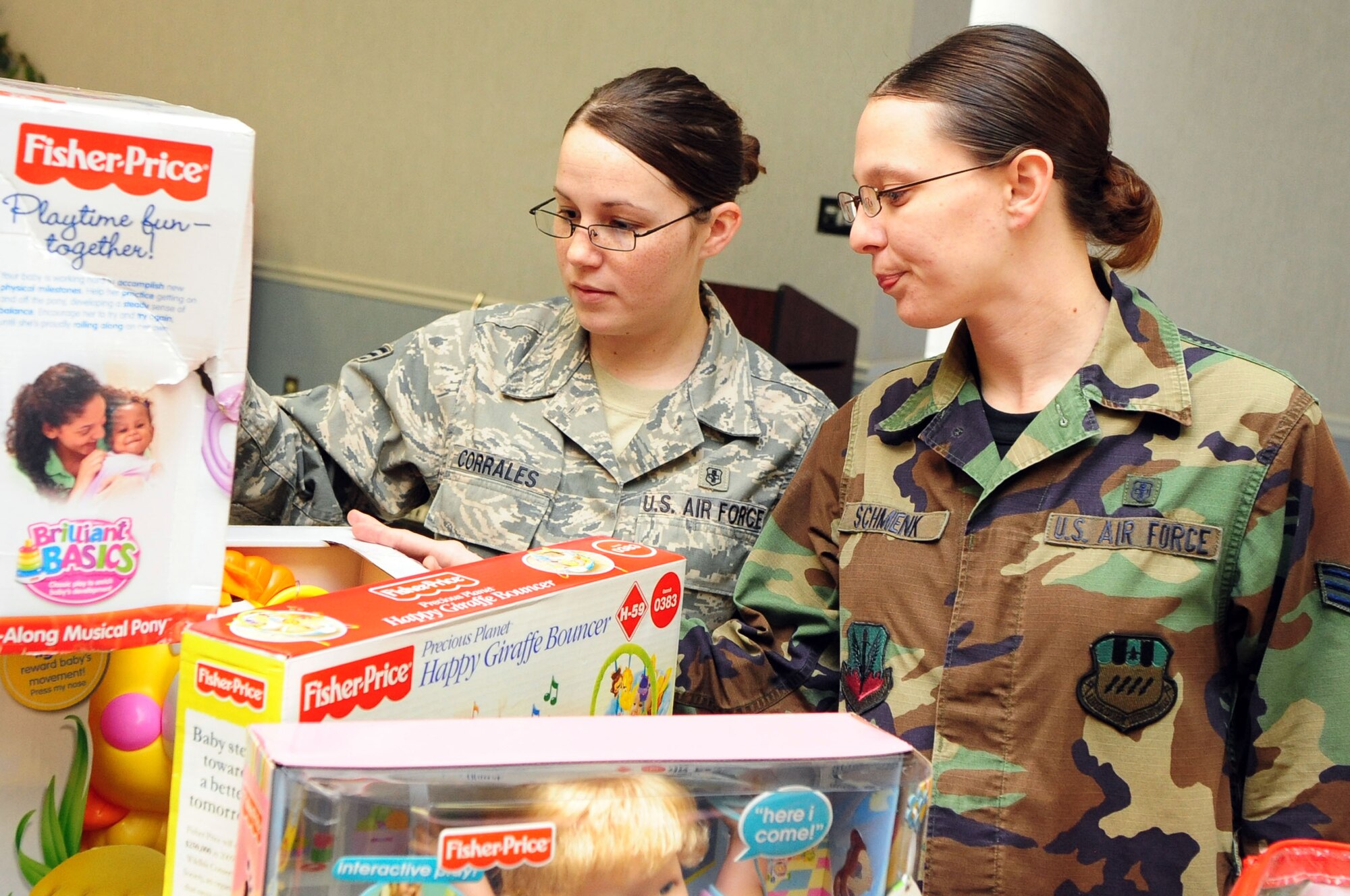 BARKSDALE AIR FORCE BASE, La. – Senior Airmen Angela Corrales and Nichole Schmenk from the 2d Medical Support Squadron browse the selection of toys at the Chapel 2 Annex, Dec. 22, as part of a secret Santa giveaway. Donations were made from the Bellaire Baptist Church, Airman’s Attic and the Santas in Blue program for military families to help with gifts this holiday. (U.S. Air Force photo by Senior Airman Joanna M. Kresge)