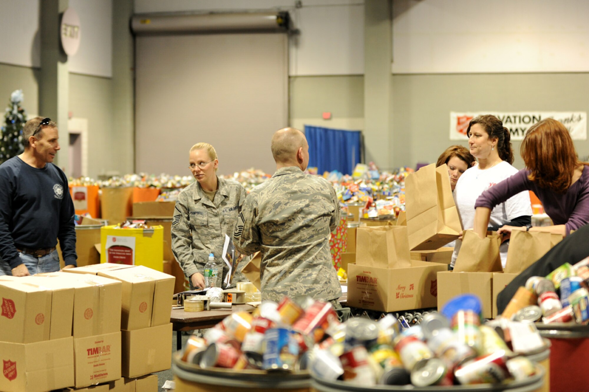 Members of the New York Air National Guard's 174th Fighter Wing, along with local volunteers fill boxes with food at the Oncenter Complex in Syracuse, NY on 22 Dec. 2009. All were assisting with the Annual Christmas Bureau Salvation ArmyFood and Gift drive supplying needy families with gifts for their children and food for their Holiday meal. (US Air Force photo by Tech. Sgt. Jeremy M. Call/Released)