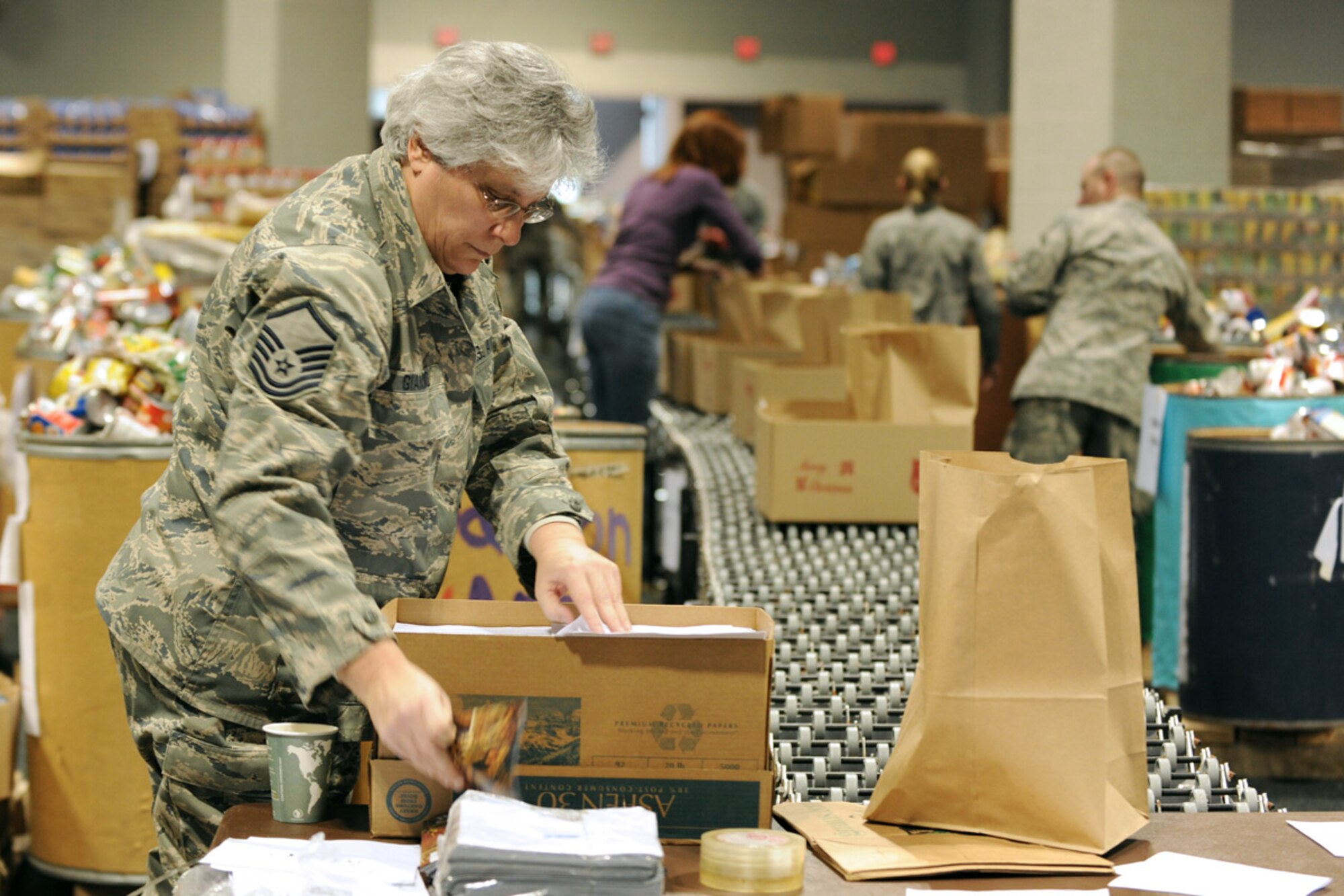 US Air Force Master Sgt. Donna M. Giambalvo packs a box at the Oncenter Complex in Syracuse, NY on 22 Dec. 2009. Giambalvo was volunteering at the Annual Christmas Bureau Salvation Army Food and Gift drive supplying needy families with gifts for their children and food for their Holiday meal. (US Air Force photo by Tech. Sgt. Jeremy M. Call/Released)