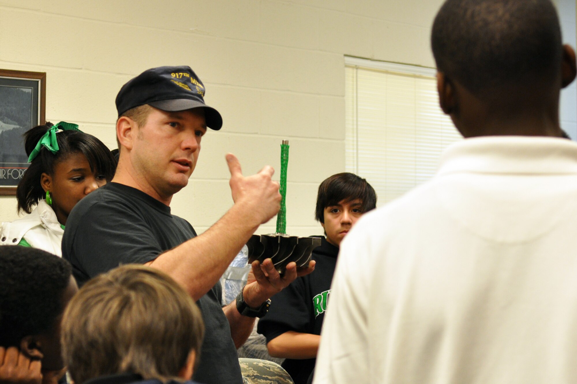 Master Sgt. Kerry Rains, a jet engine mechanic for the 917th Wing on Barksdale Air Force Base, La., answers questions about different engines and the mechanics of them during a base tour of the 917th Wing on Barksdale Air Force Base, La. December 21, 2009. Sergeant Rains entertained 32 students who attained the highest grade point averages from the aerospace course at Rusheon Middle School in Bossier City, La., with fun facts and statistics about the different engines that pass through his maintenance shop. (U.S. Air Force Photo/ Senior Airman Crystal Marie Jordan)